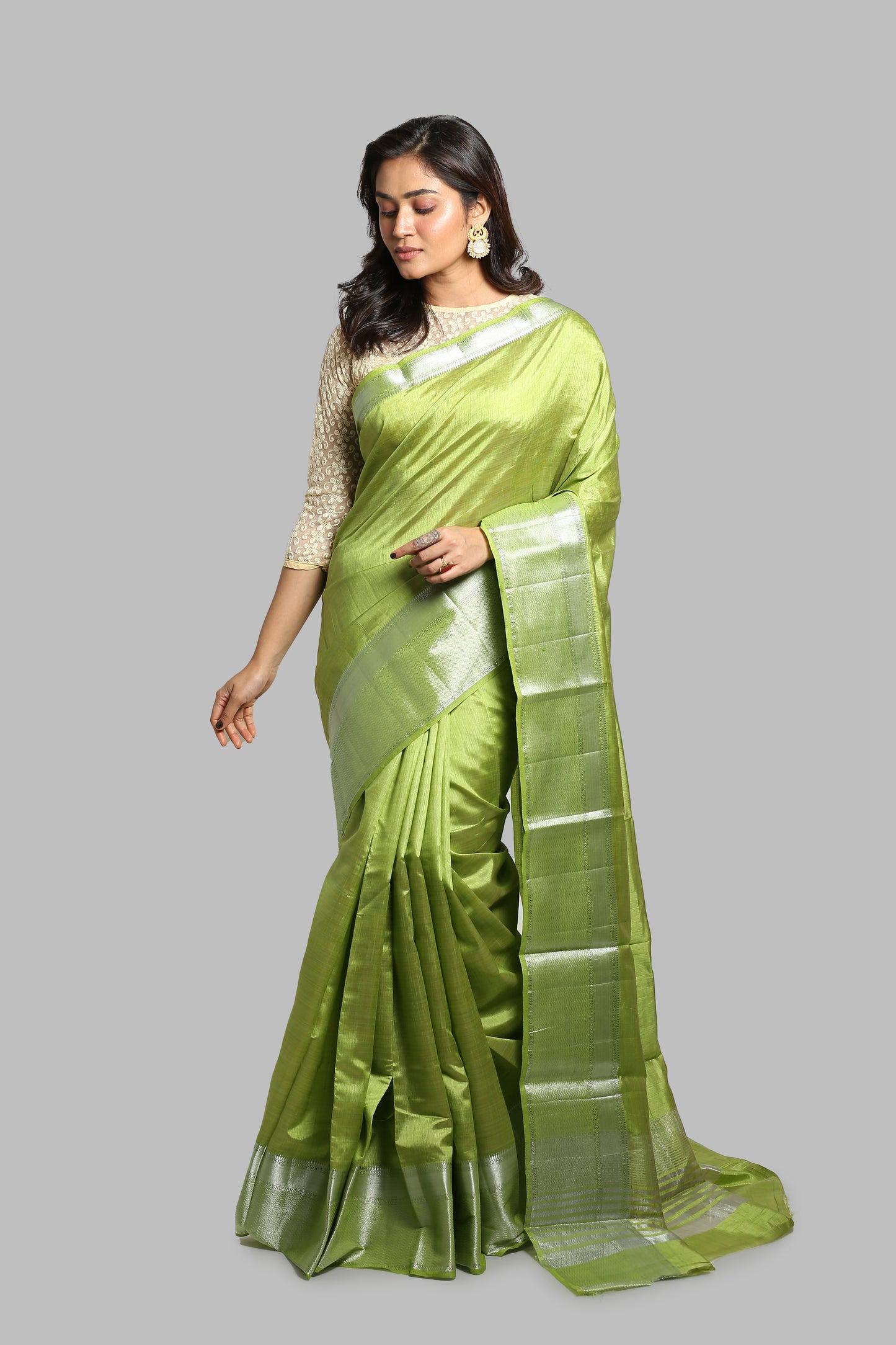 Aromatic Mead raw silk saree: plain green body, silver zari border, traditional wear. | Urbane Essence
