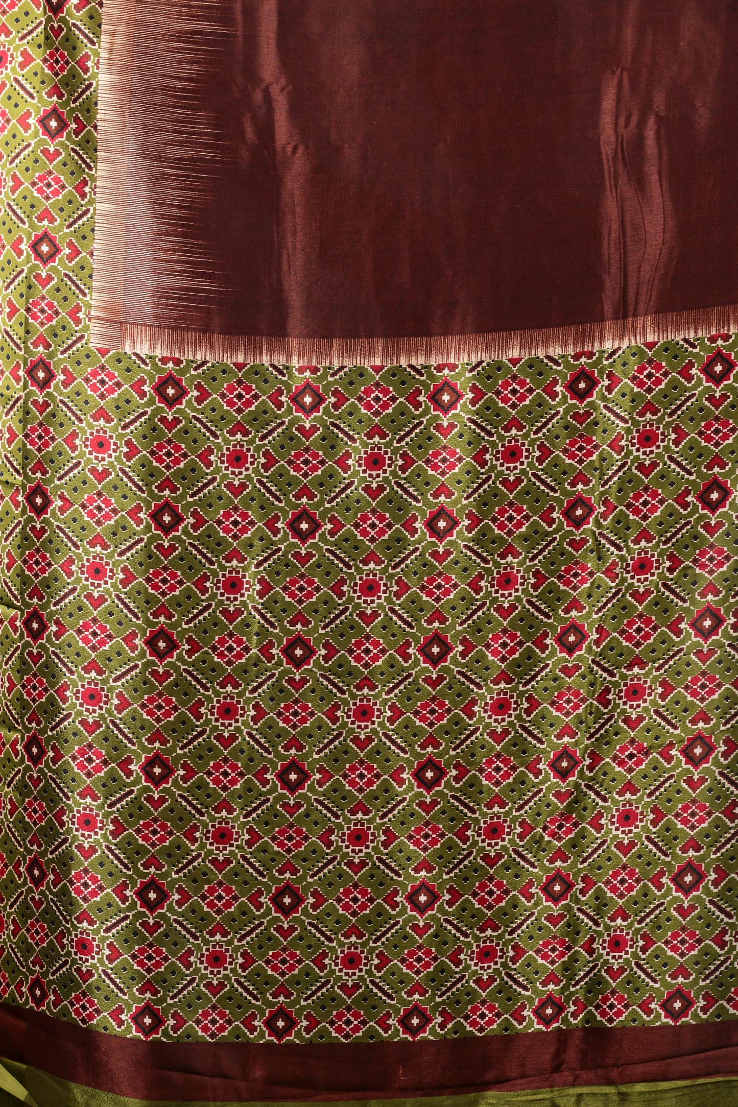 Olive green blend silk saree with red ikat motifs and a rich brown pallu, perfect for festive occasions | Urbane Essence