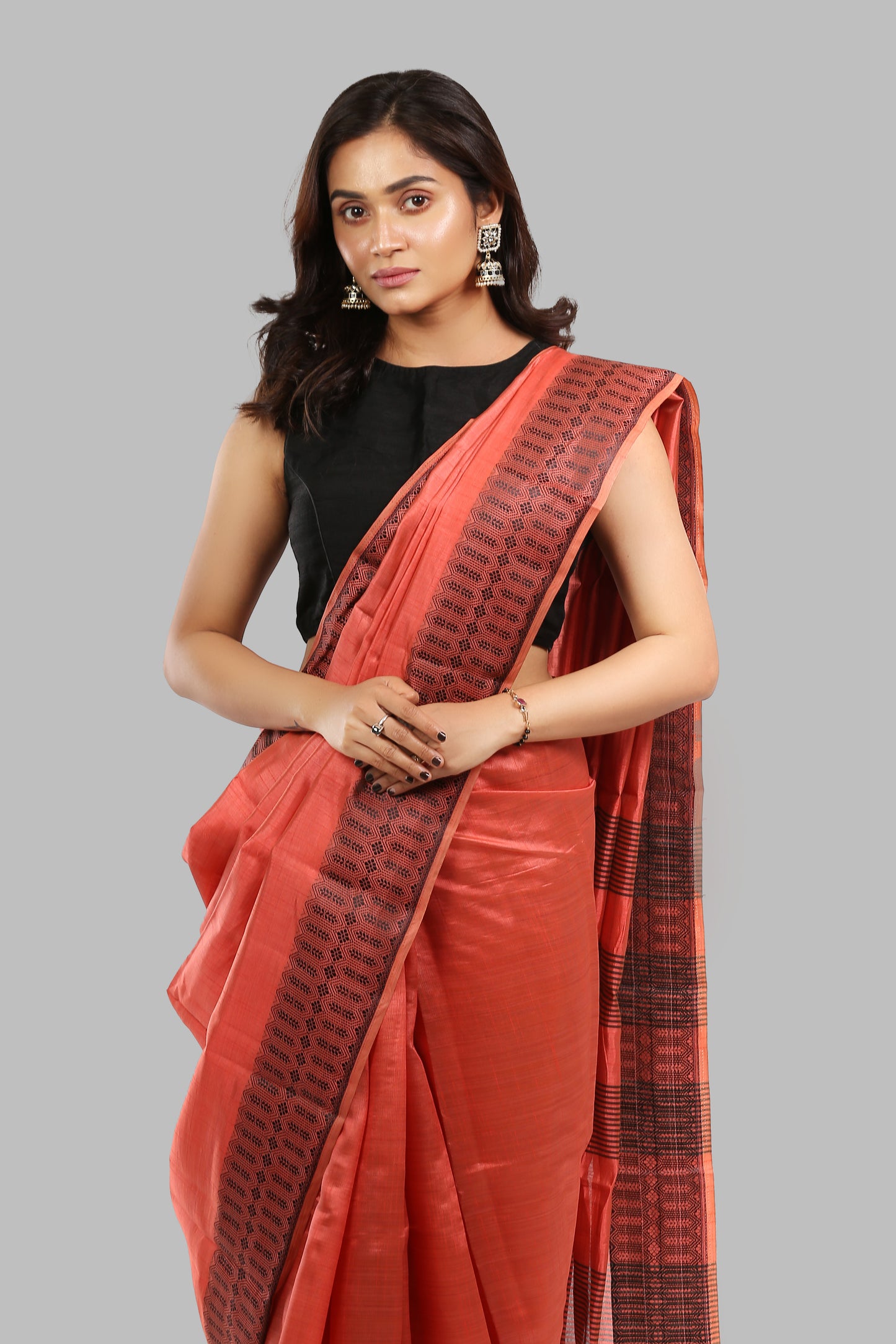 Sun-kissed rosewood raw silk saree with broad green border, golden zari patterns, traditional occasion | Urbane Essence
