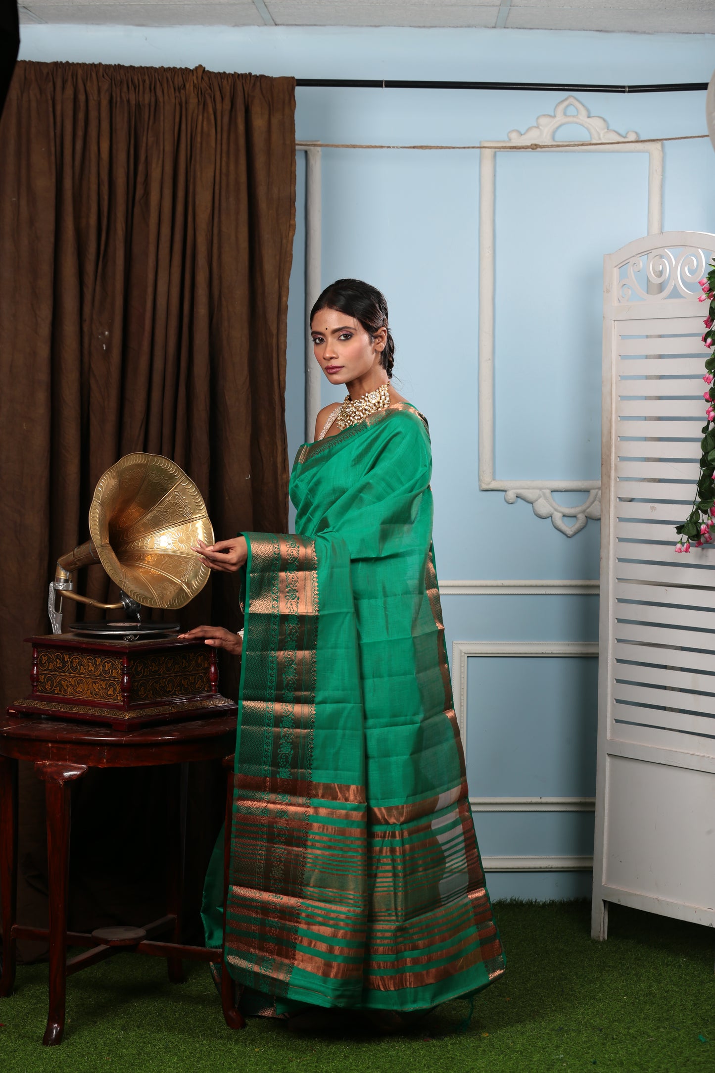 Munsell green raw silk saree with golden copper border, perfect for celebratory occasions | Urbane Essence