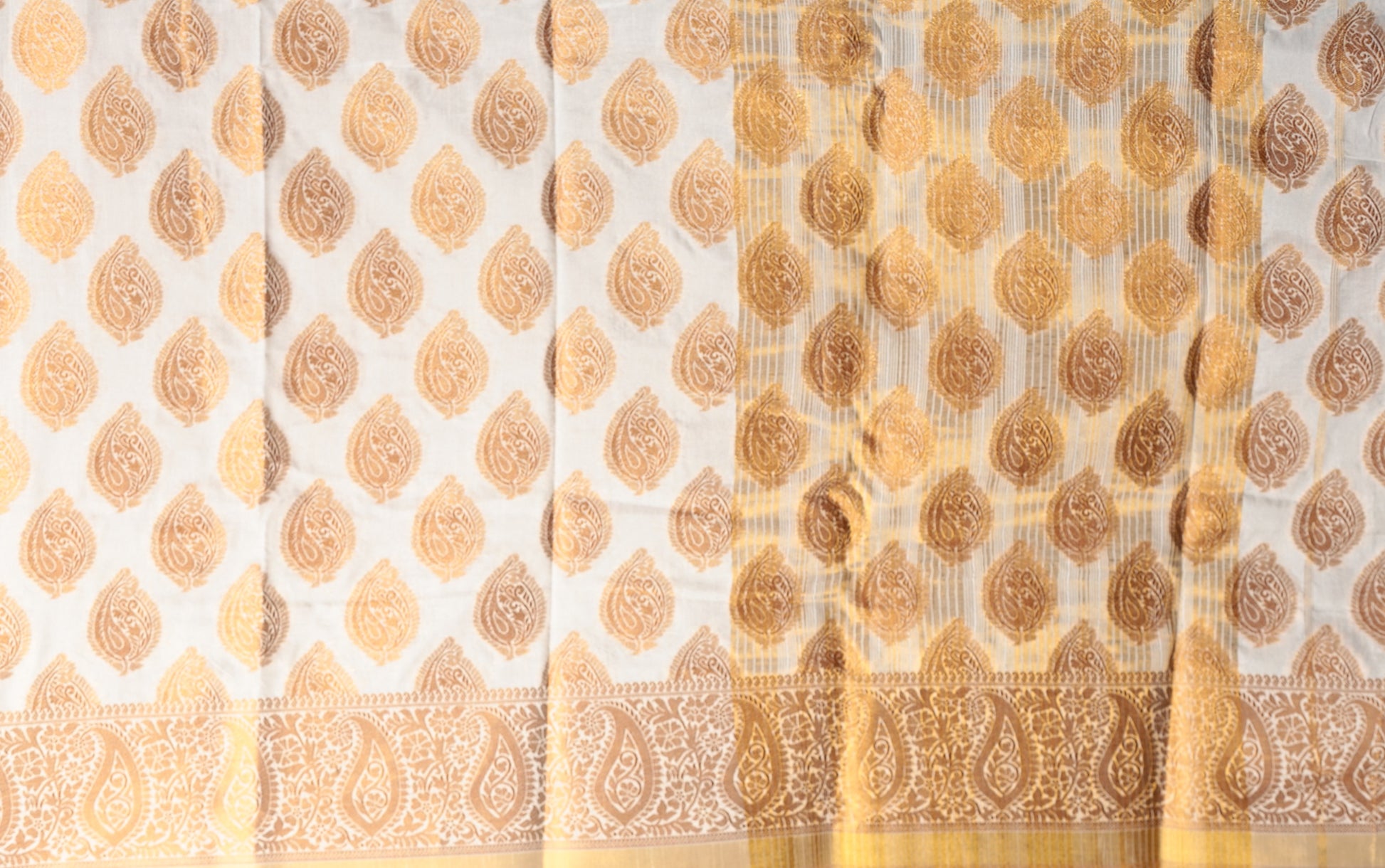 White and gold South silk saree with traditional paisley patterns, ideal for professional events or Pujas | Urbane Essence