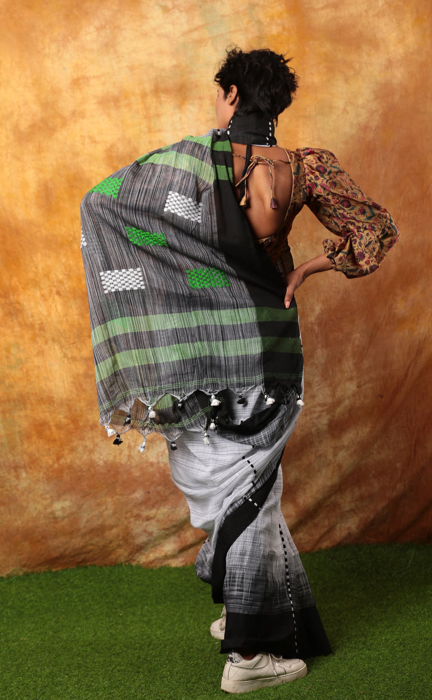 Model from behind wearing a black and white Bengal Khadi saree with green accents, suitable for official events | Urbane Essence