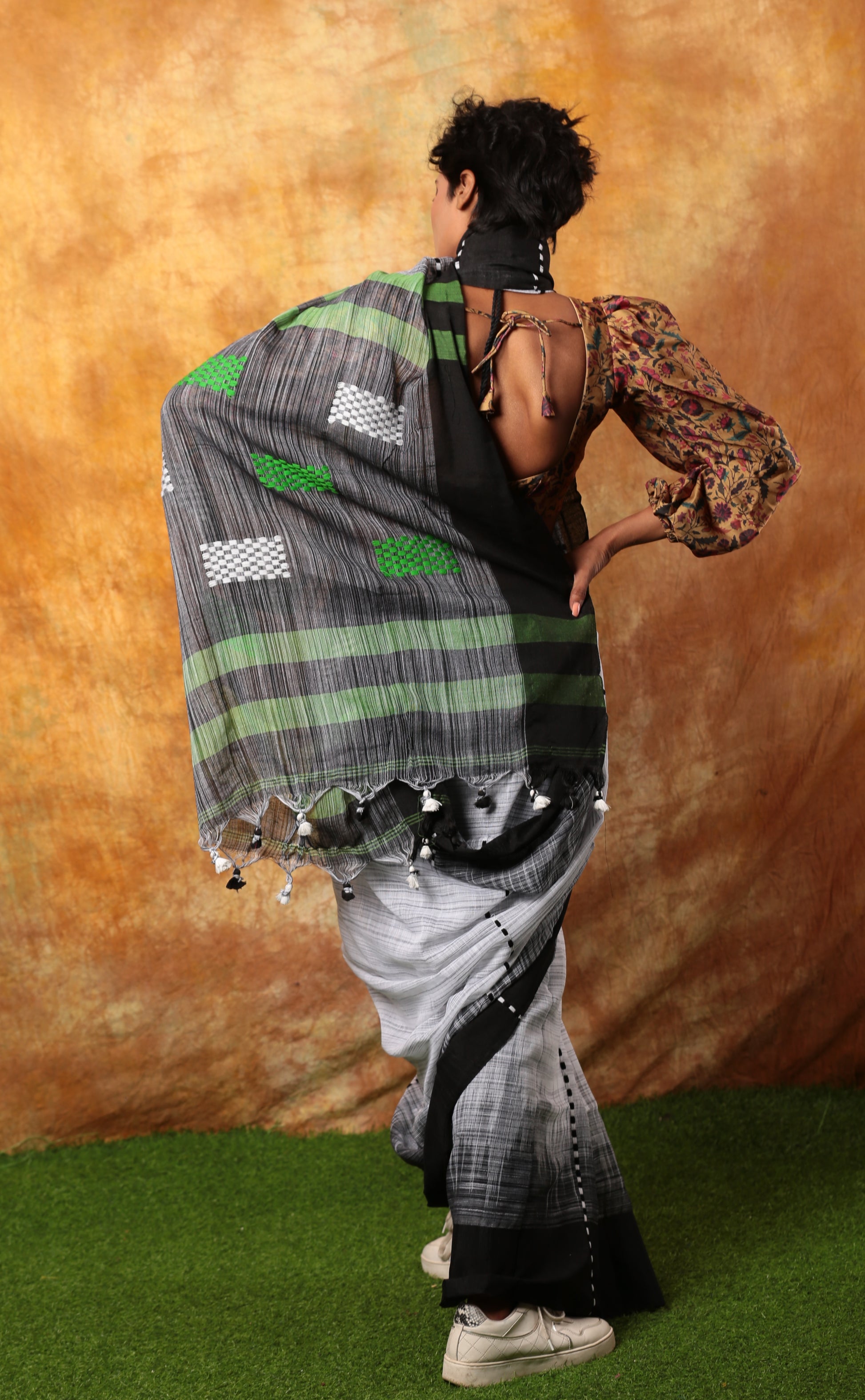 Model from behind wearing a black and white Bengal Khadi saree with green accents, suitable for official events | Urbane Essence