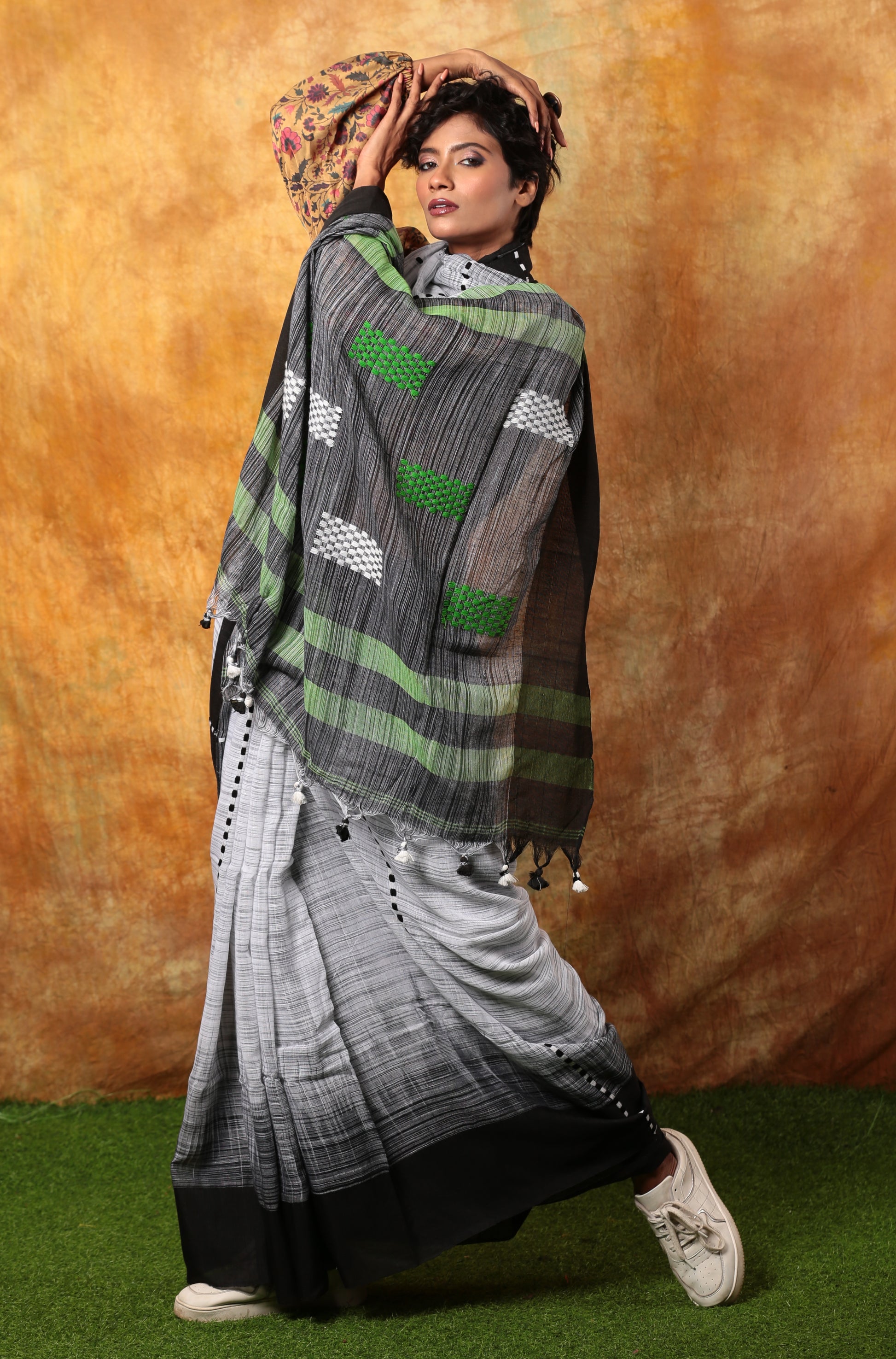 Model in black & white Bengal Khadi saree with green & white pallu, suitable for corporate events | Urbane Essence