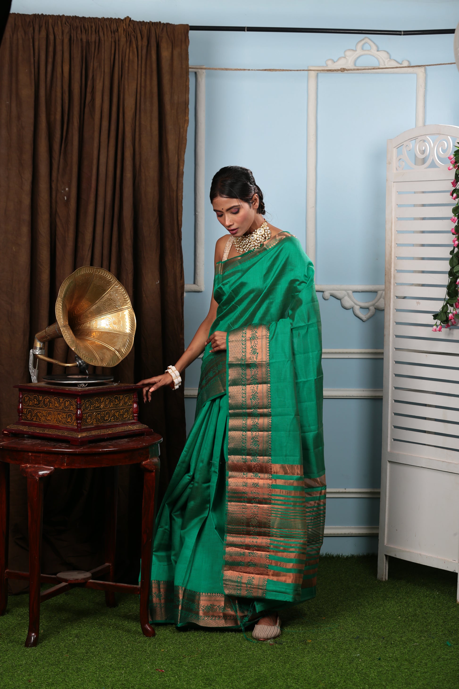 Model in green raw silk saree with Harappan-inspired floral pallu, perfect for temple wear | Urbane Essence