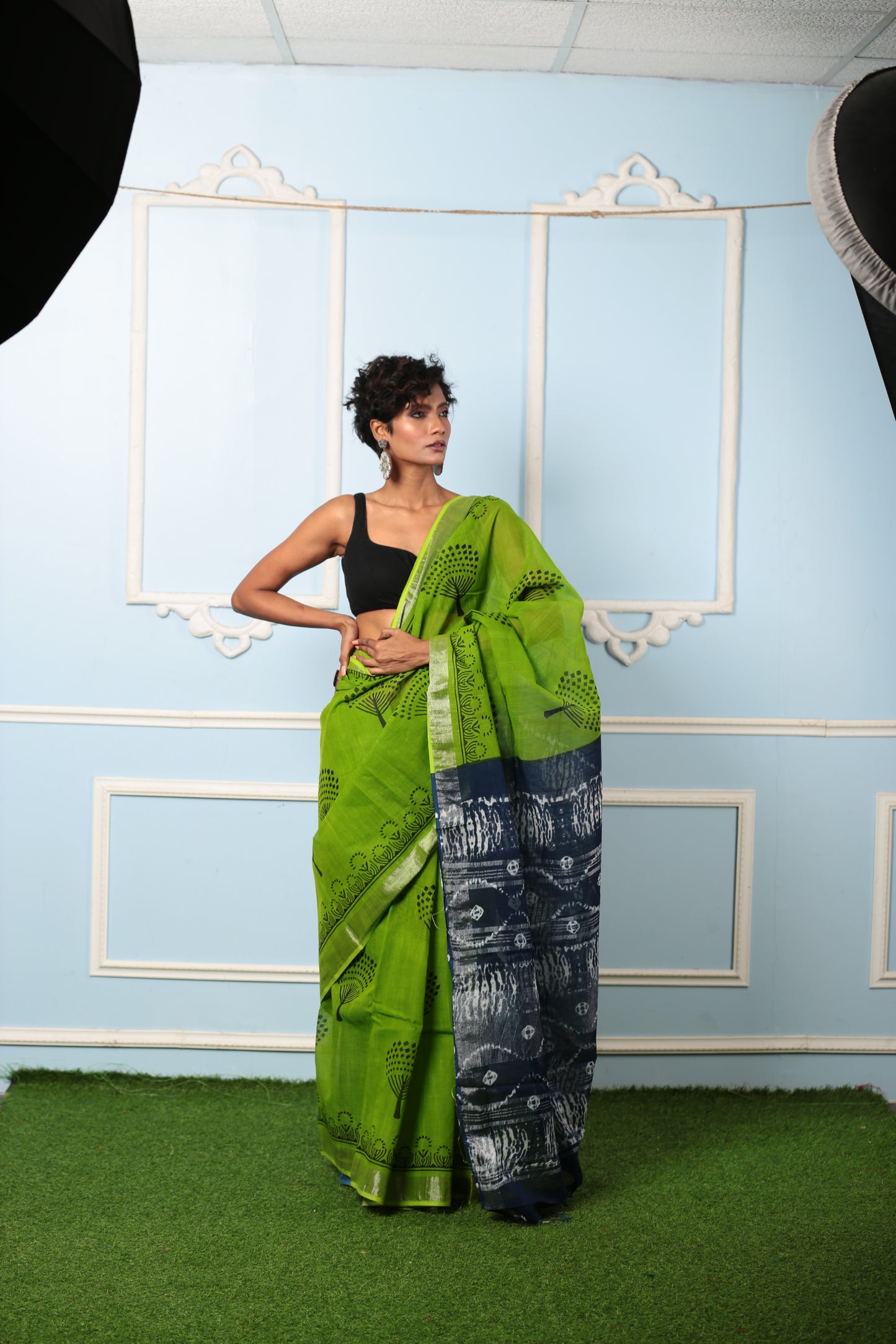 Woman in a parrot green and dark grey Jaipur cotton saree with intricate pallu patterns, suitable for professional or celebratory wear | Urbane Essence