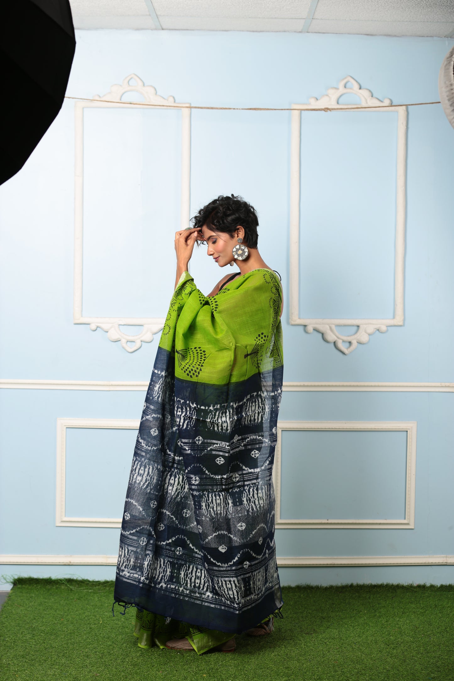 Model in a parrot green and dark grey Jaipur cotton saree with intricate pallu patterns, suitable for professional or celebratory wear | Urbane Essence
