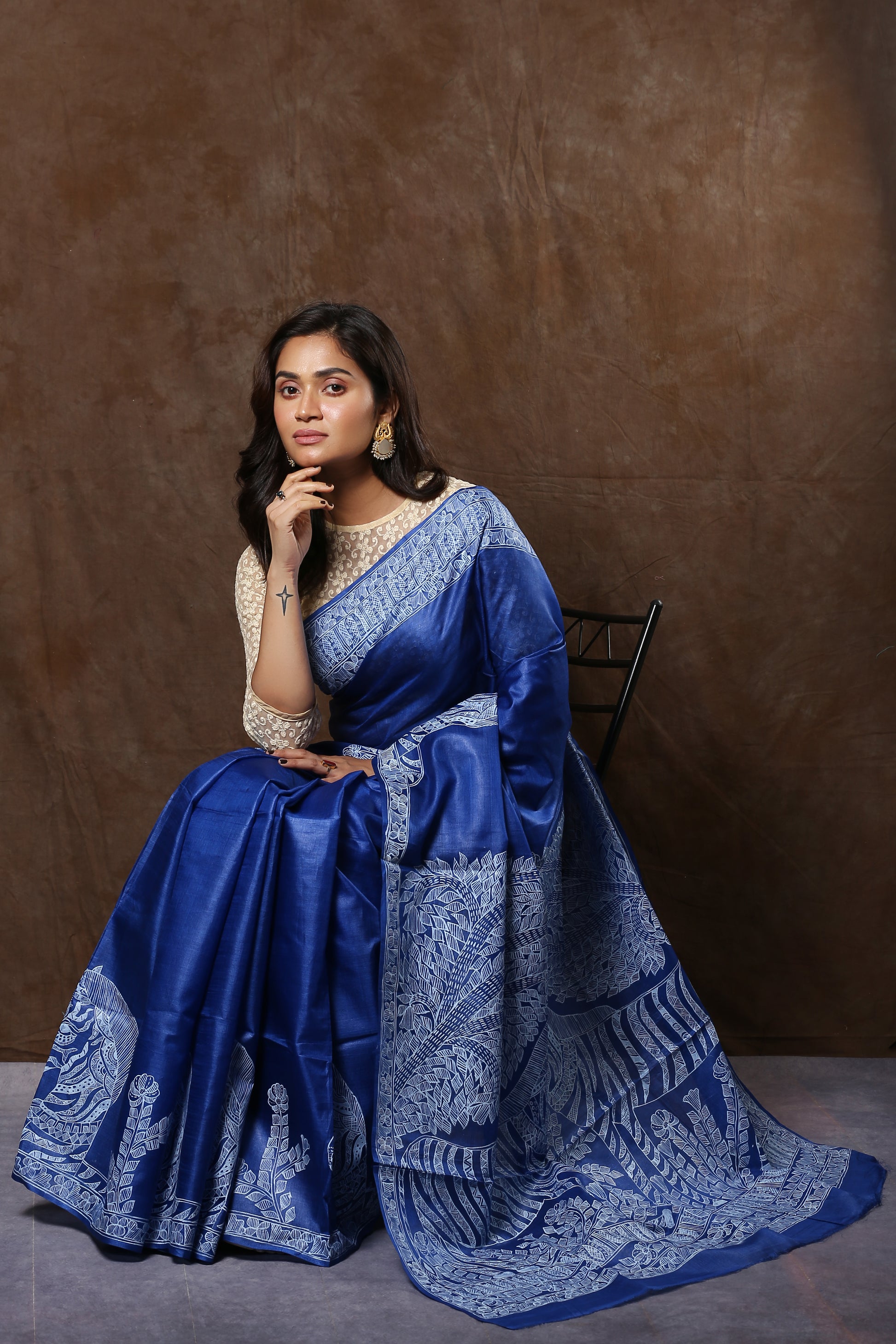 Woman in a blue Tussar silk saree with white Madhubani art, perfect for festive occasions | Urbane Essence