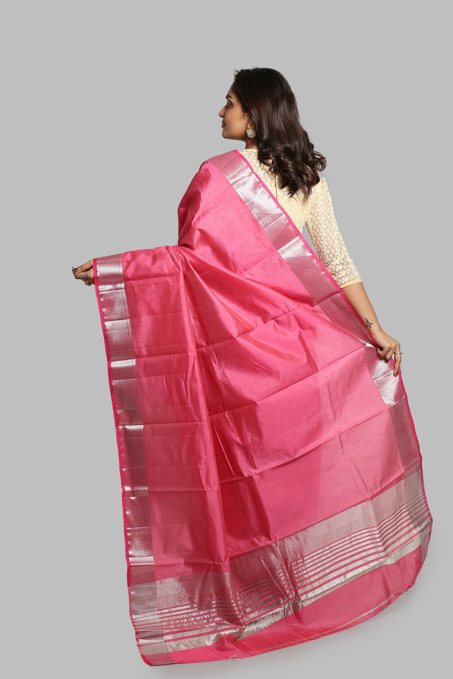 Flamingo pink raw silk saree with broad silver zari border and geometric pallu, perfect for professional occasions | Urbane Essence