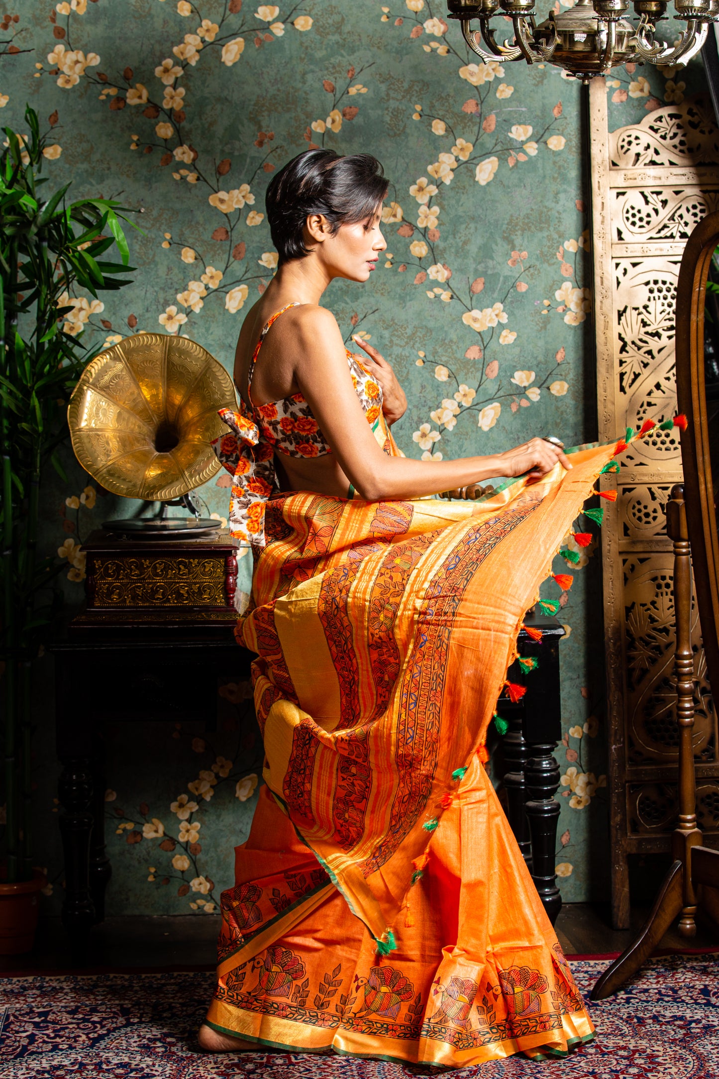 Model in an orange Tussar silk Madhubani saree, perfect for glamorous evenings | Urbane Essence