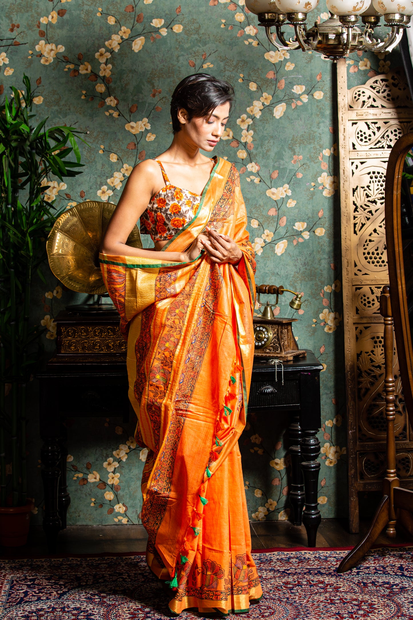 Woman in orange Tussar silk Madhubani saree, perfect for glamorous evenings | Urbane Essence