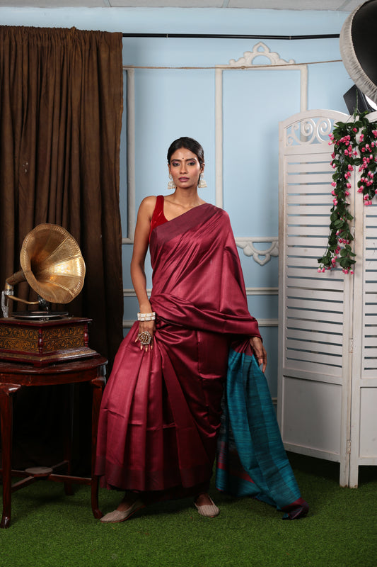 Woman in a handwoven carmine and cobalt blue Tussar silk saree, perfect for elegant occasions | Urbane Essence
