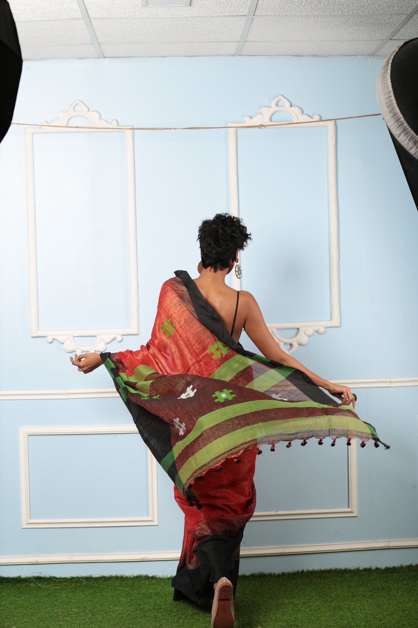 Red and black raw silk saree with green stripes and tassels, perfect for festive occasions | Urbane Essence