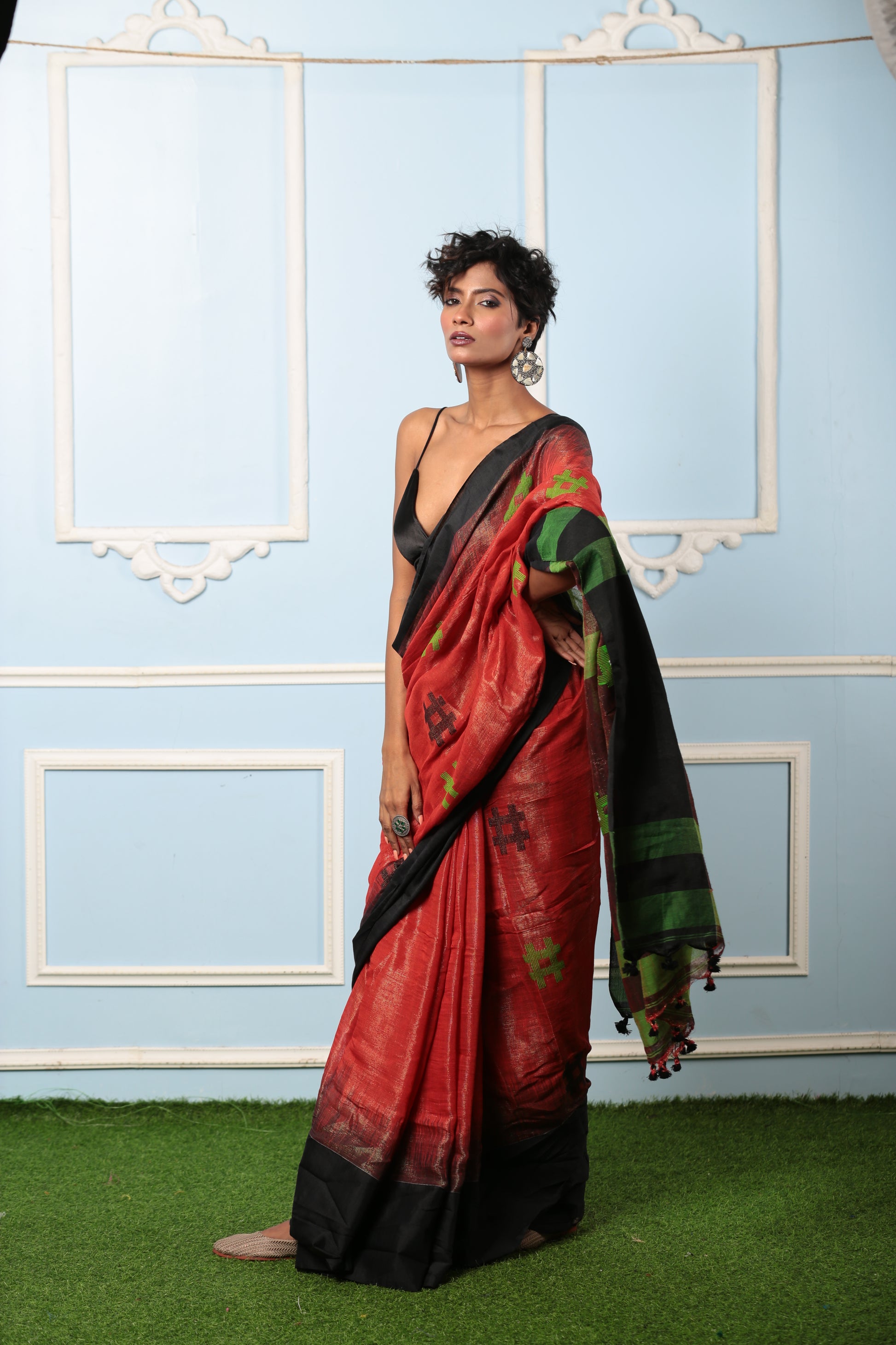 Red raw silk saree with black and green accents, perfect for festive occasions. | Urbane Essence