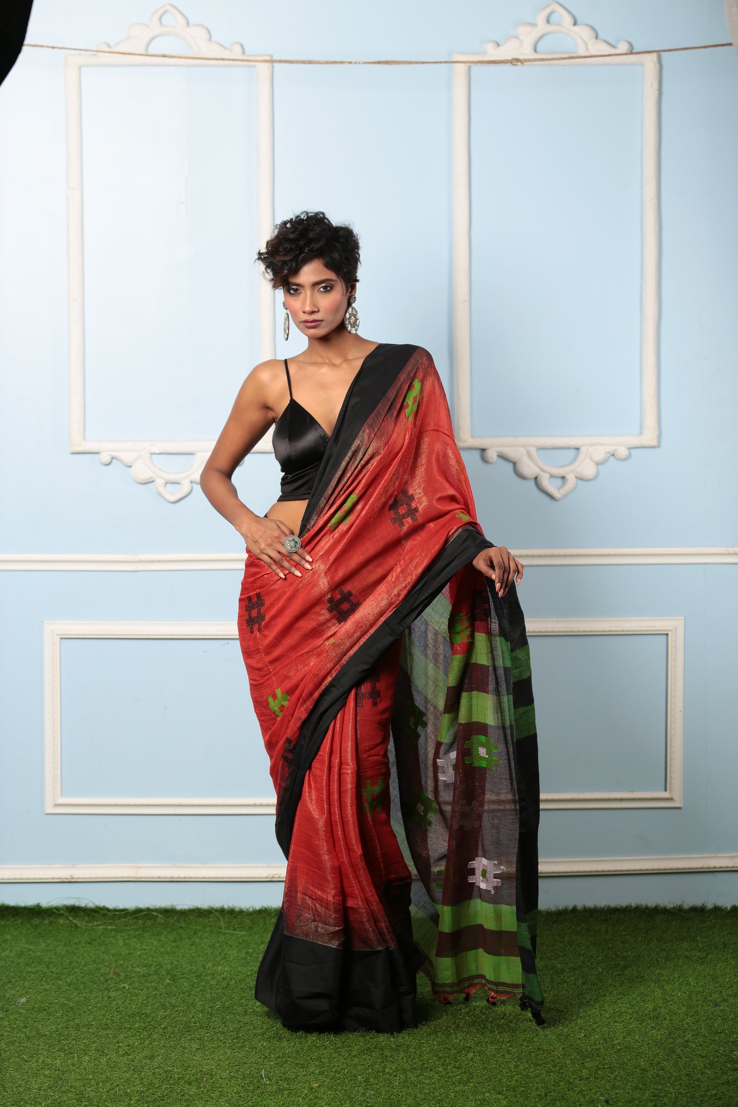 Red raw silk saree with black and green ikat pallu, perfect for festive occasions | Urbane Essence
