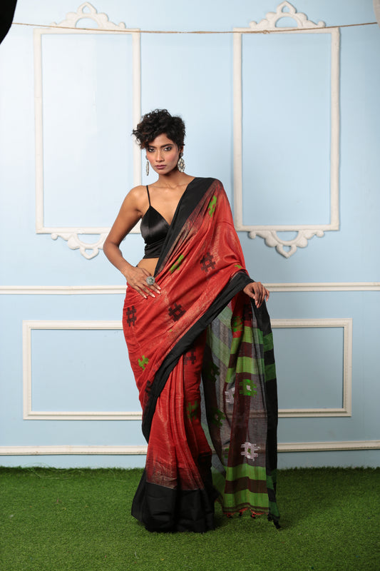 Red raw silk saree with black and green ikat pallu, perfect for festive occasions | Urbane Essence