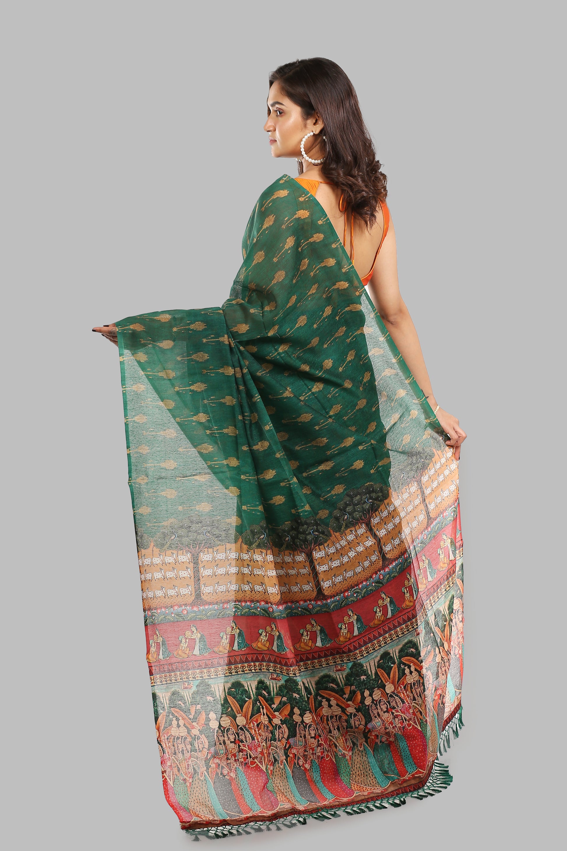 Deep green raw silk saree with all-over patterns and a pallu featuring ancient wall painting figures, perfect for traditional occasions | Urbane Essence