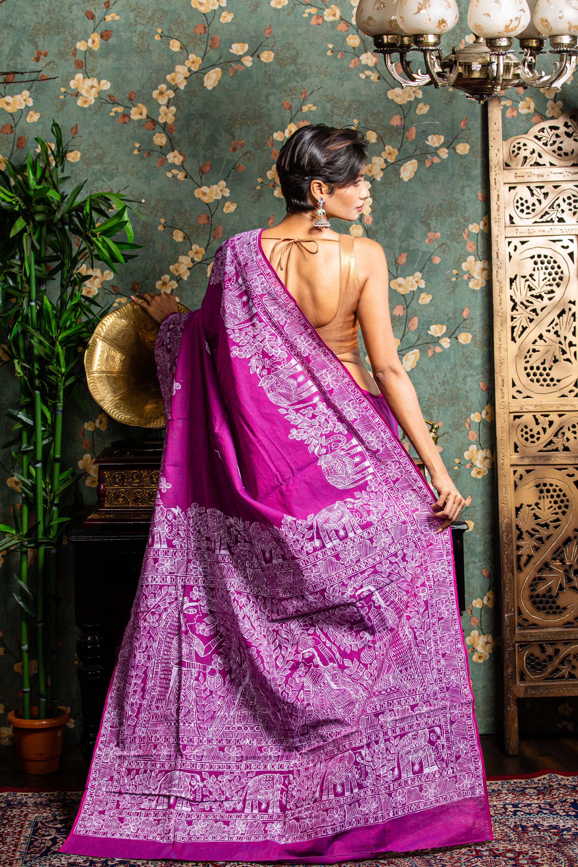 Woman in a magenta Tussar silk saree with white Madhubani painting, perfect for cultural events | Urbane Essence