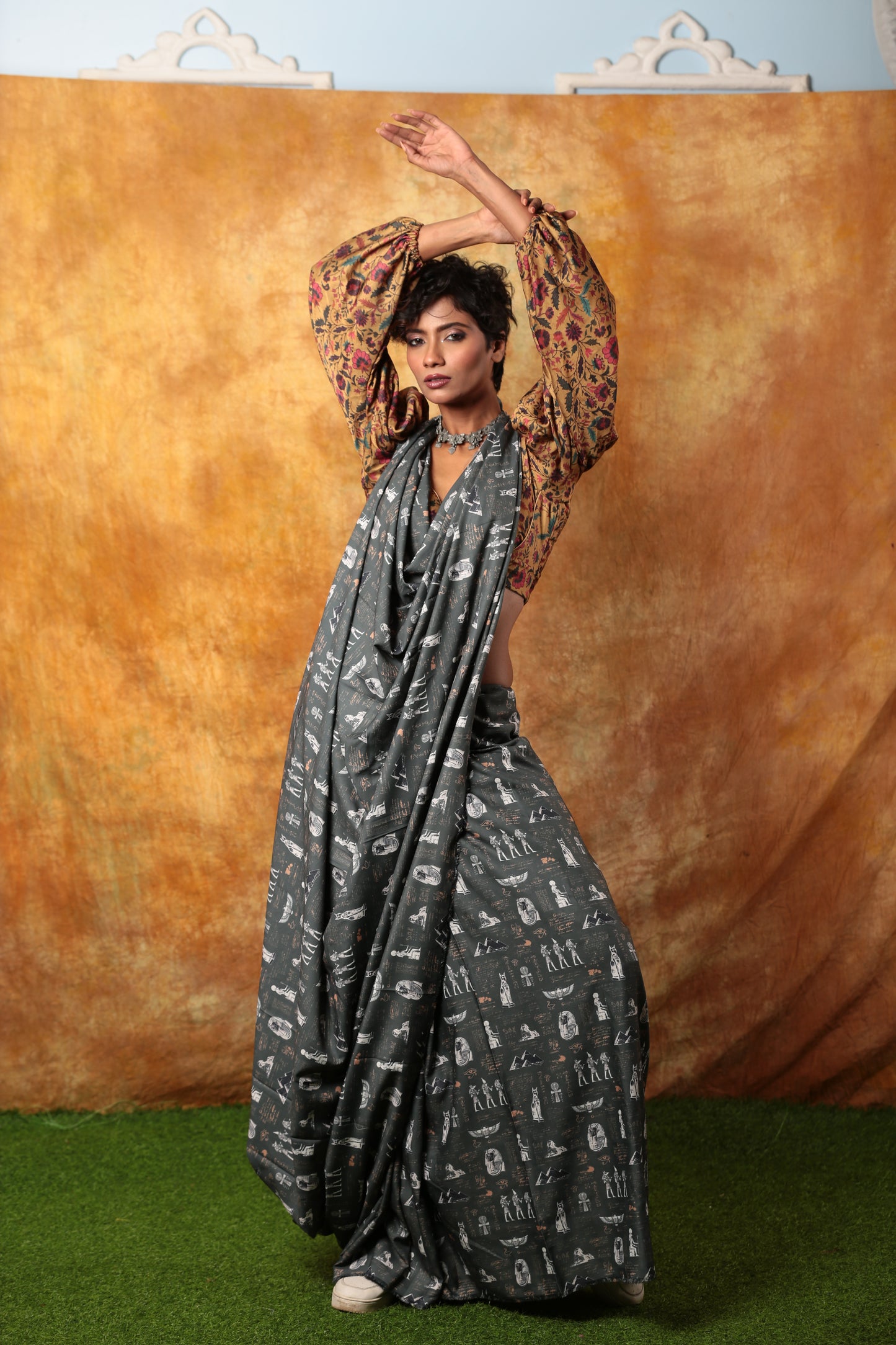 Grey Egyptian print saree with white hieroglyphics, paired with a floral blouse, suitable for unique occasions | Urbane Essence