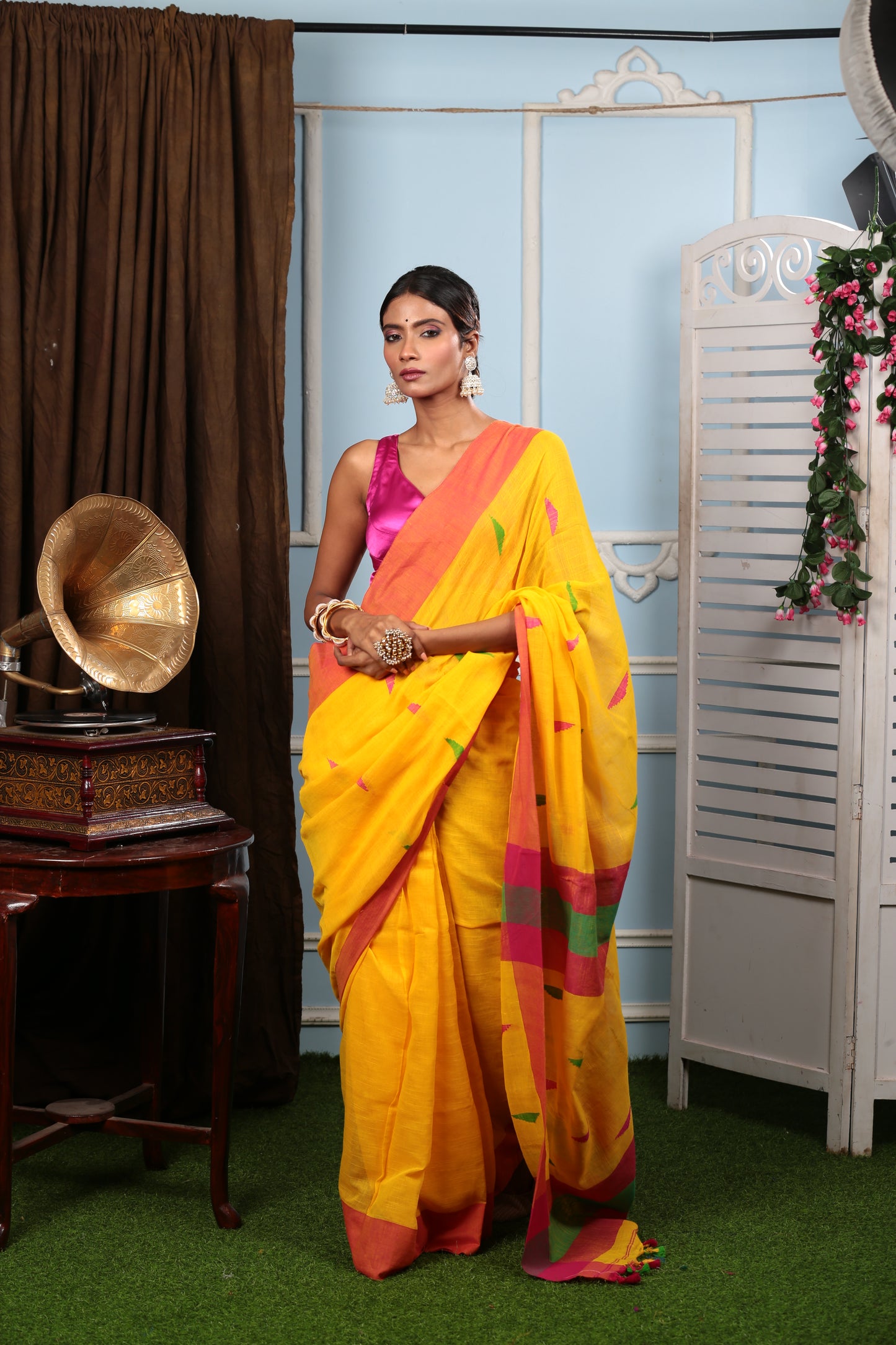 Model in a vibrant yellow Bengal khadi saree with multi-colored prints, perfect for summer. | Urbane Essence