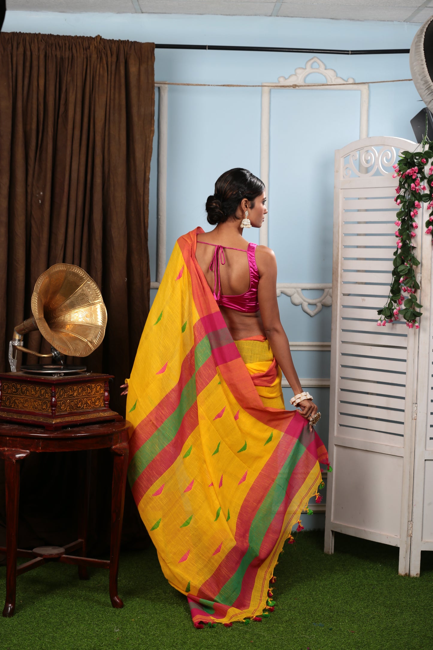 Model in yellow Bengal khadi saree with multi-colored prints and red border, perfect for summer | Urbane Essence