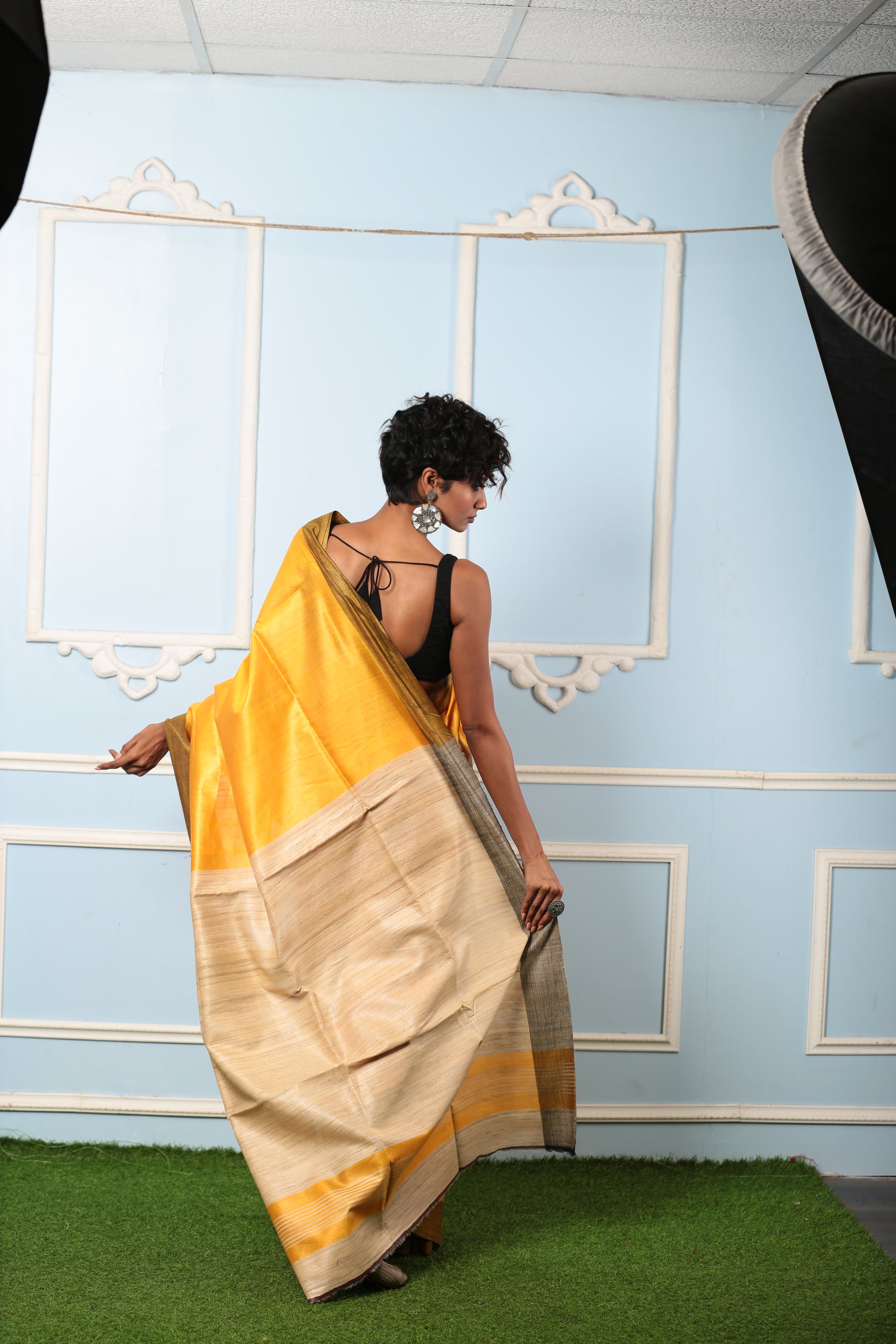 Woman in a golden yellow Purulia Tussar silk saree, ideal for day occasions. | Urbane Essence