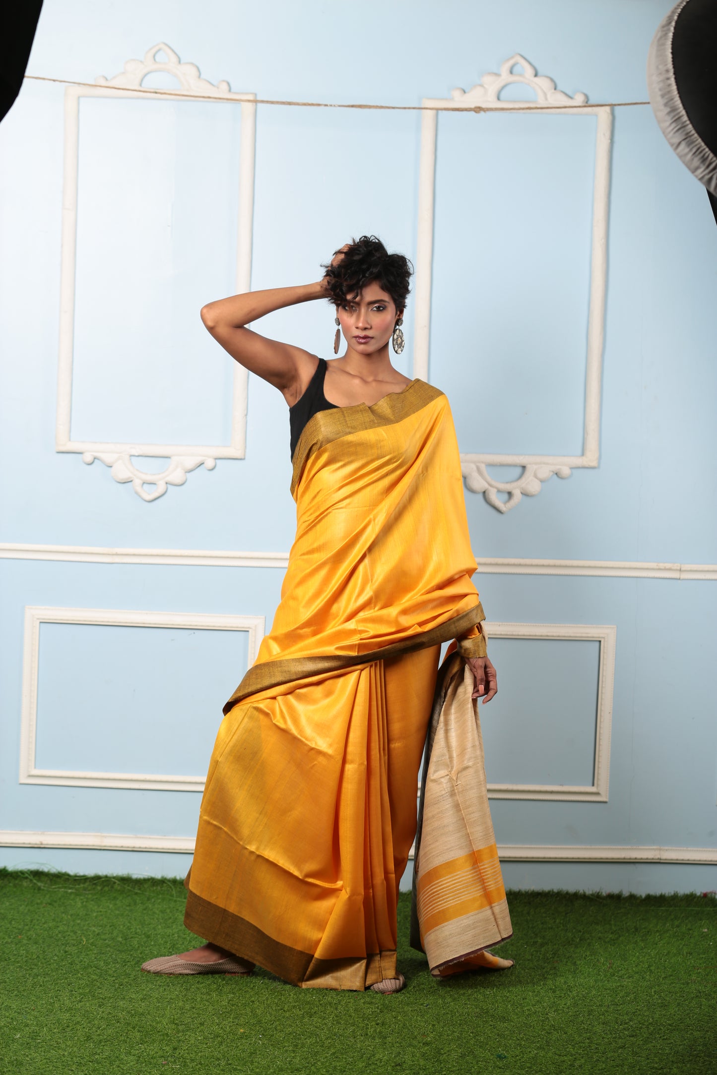 Model in a vibrant yellow Purulia Tussar silk saree, perfect for day occasions. | Urbane Essence