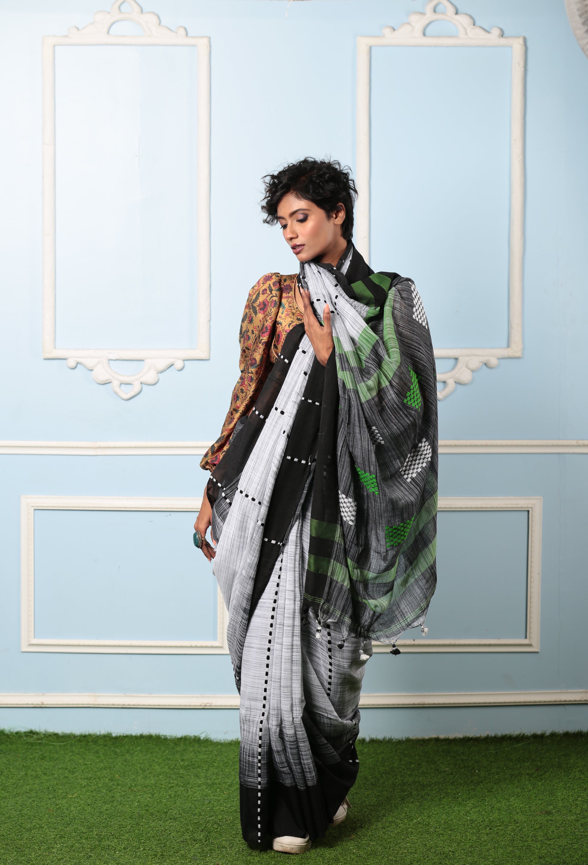 Model in a white and black Assam Khadi saree with traditional patterns, ideal for summer mornings | Urbane Essence