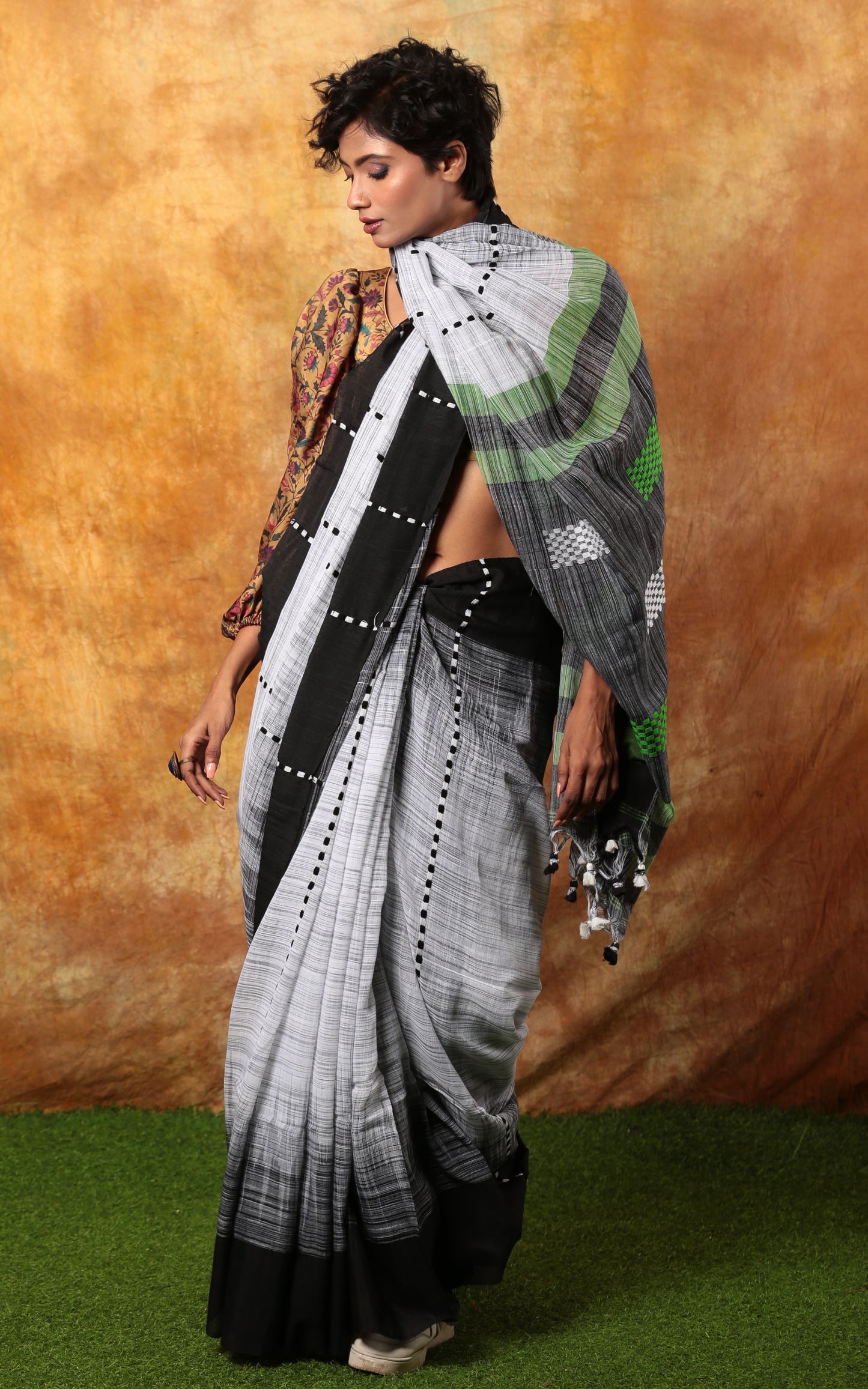White and black Assam Khadi saree with traditional patterns, tassels, ideal for summer morning events | Urbane Essence