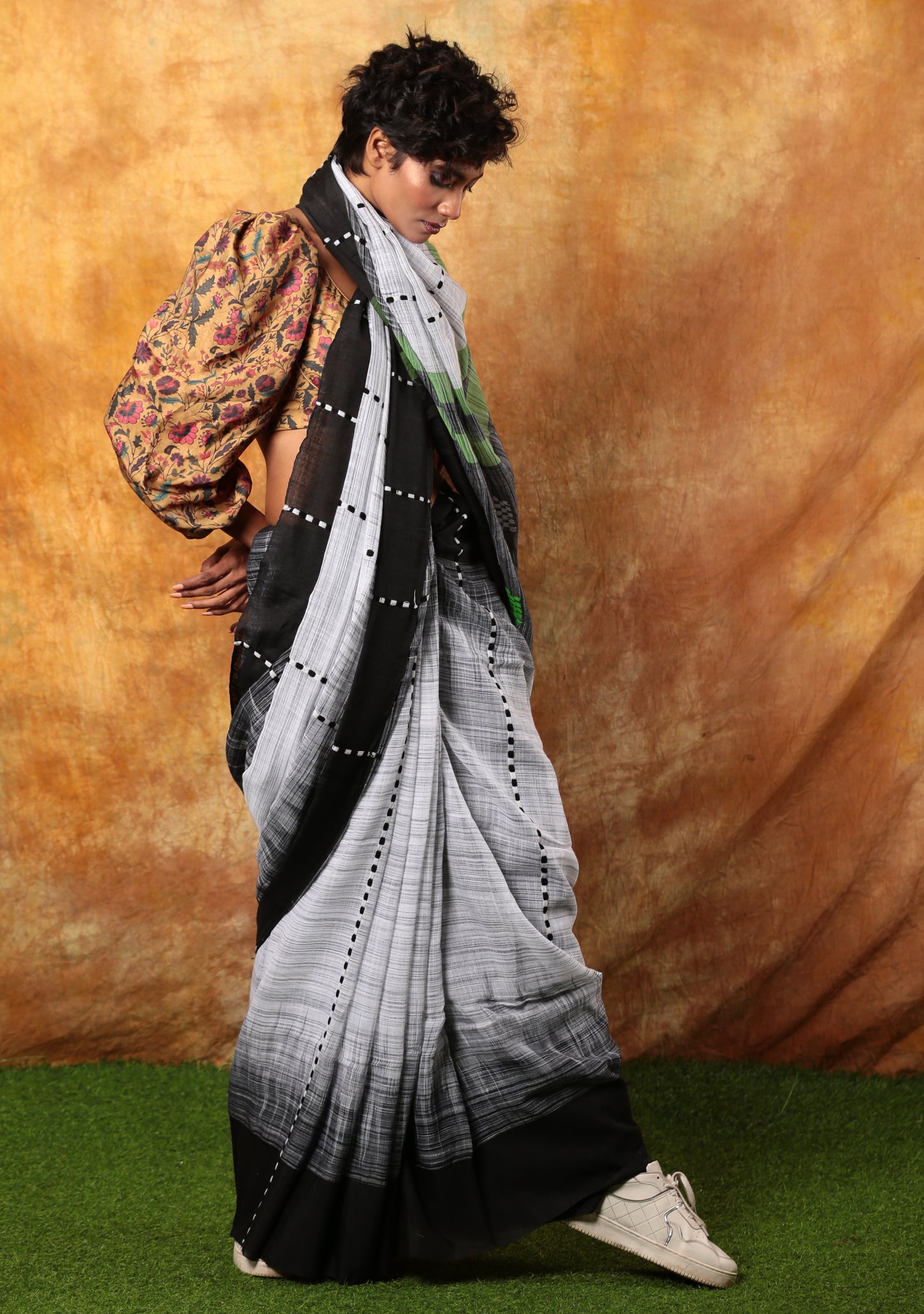 White and black Assam Khadi saree with traditional patterns, perfect for summer morning events | Urbane Essence