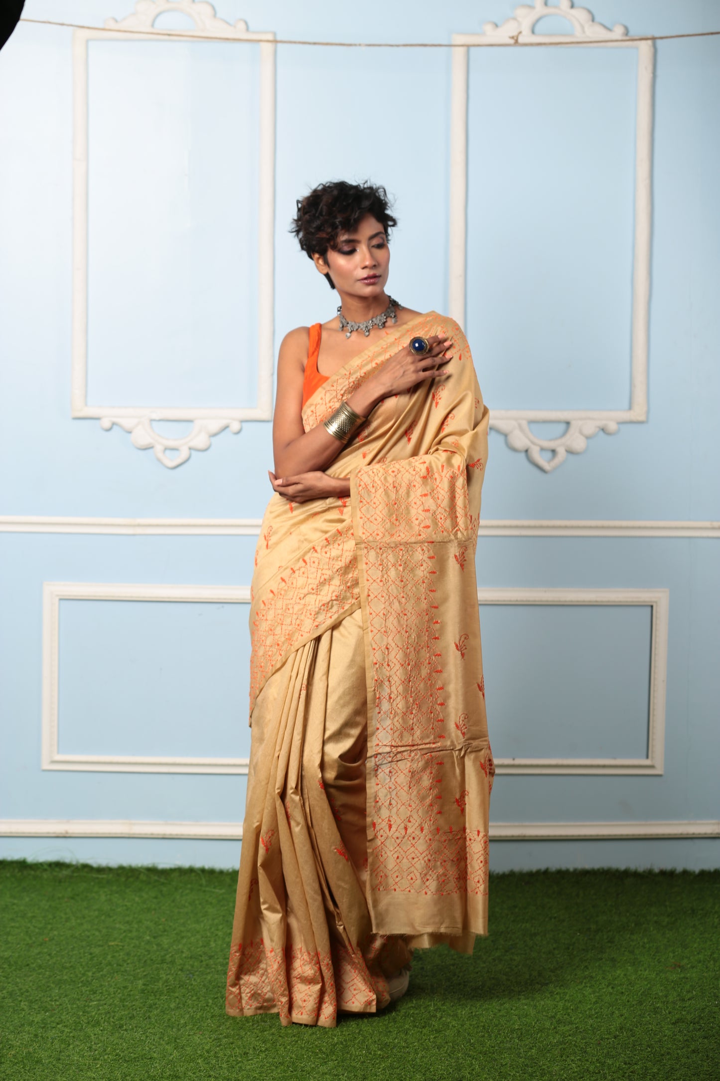 Beige Kantha saree with orange stitch patterns, ideal for traditional events. | Urbane Essence