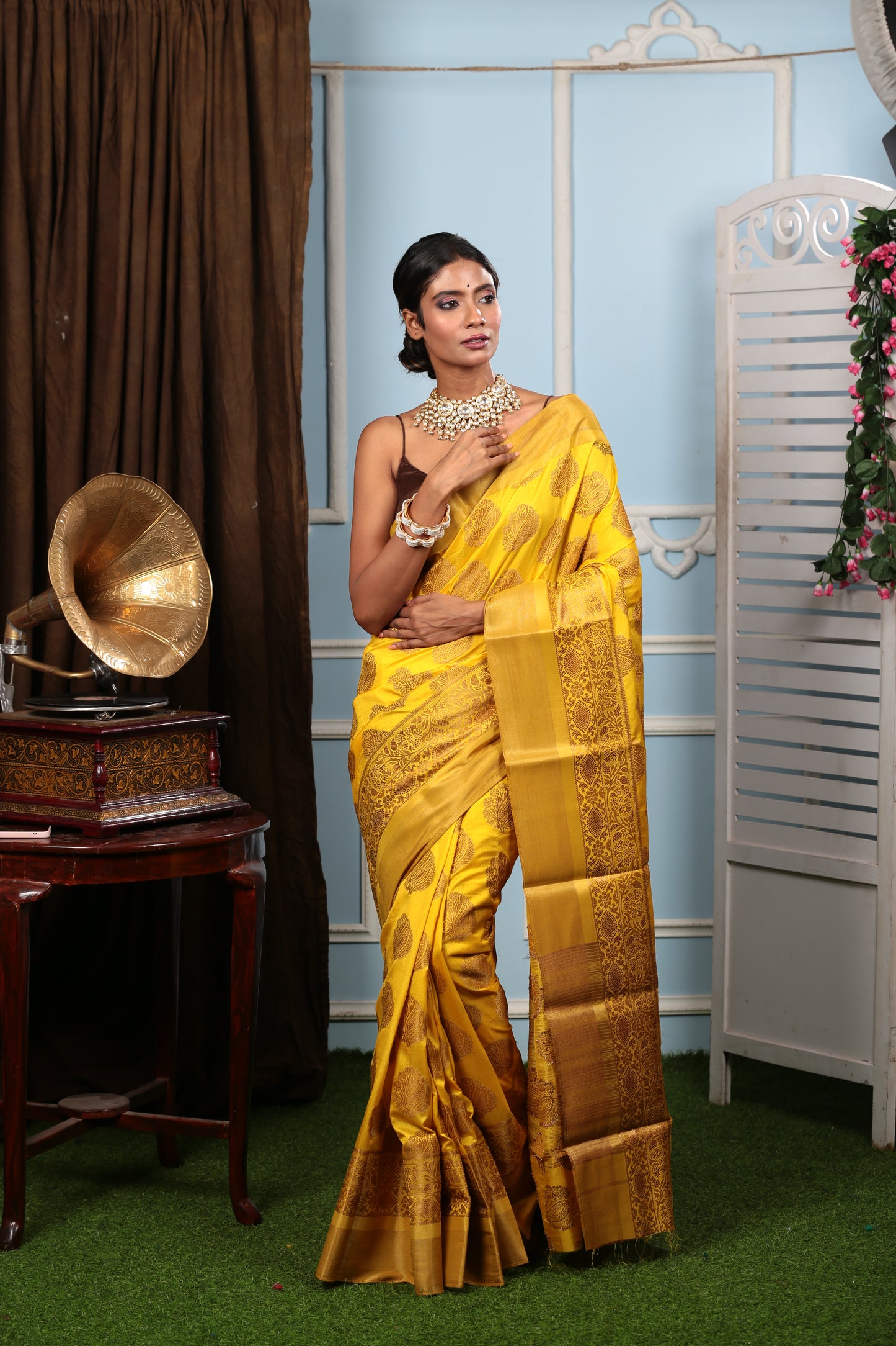 Woman in bright yellow South silk saree with brown border, ideal for fun events | Urbane Essence