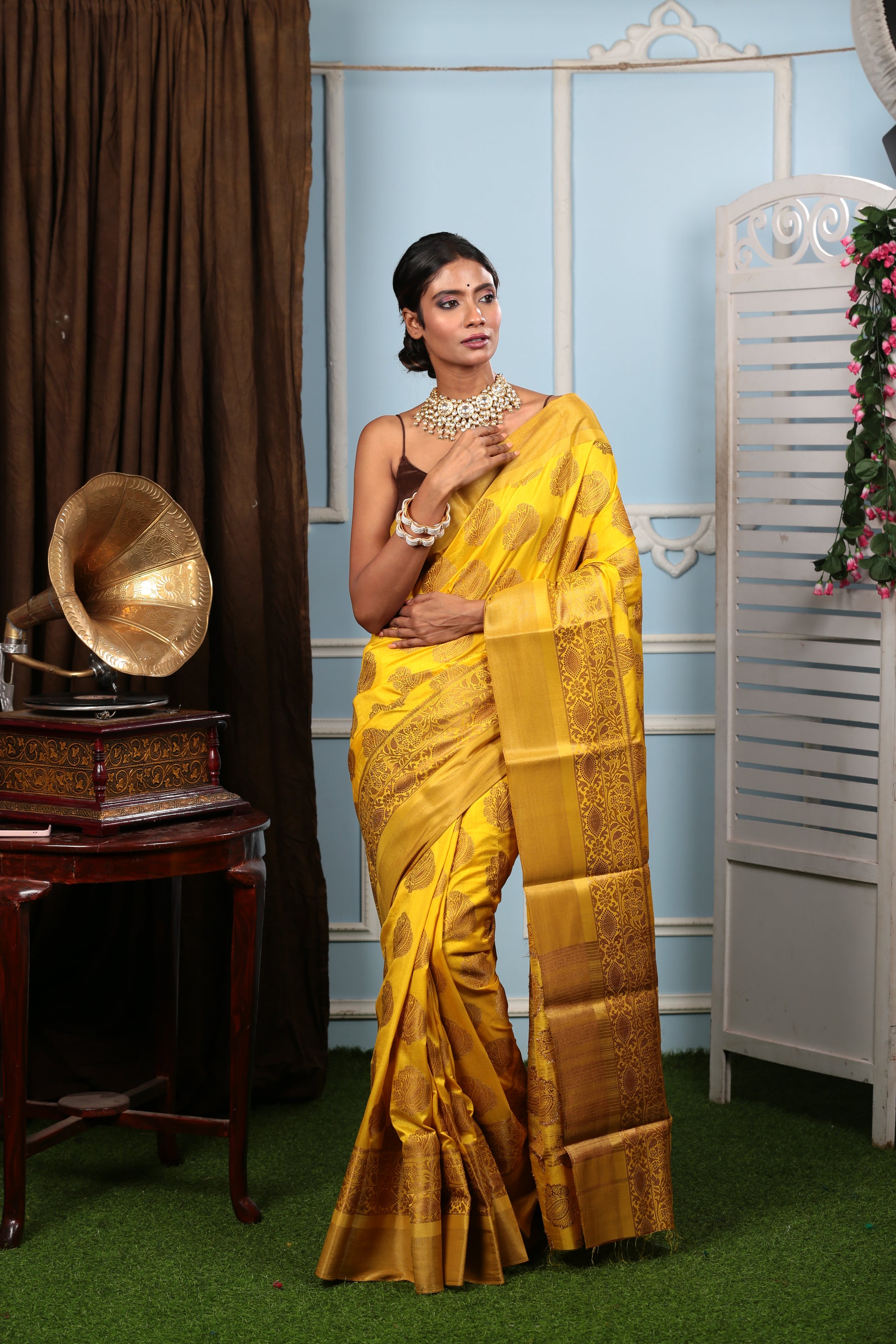 Woman in bright yellow South silk saree with brown border, ideal for fun events | Urbane Essence