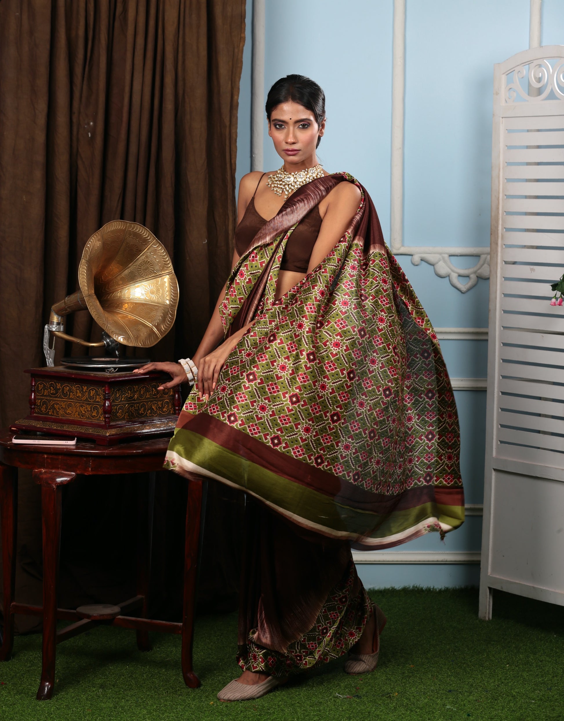 Brown blend silk Patola saree with green and red geometric patterns, ideal for festive occasions | Urbane Essence