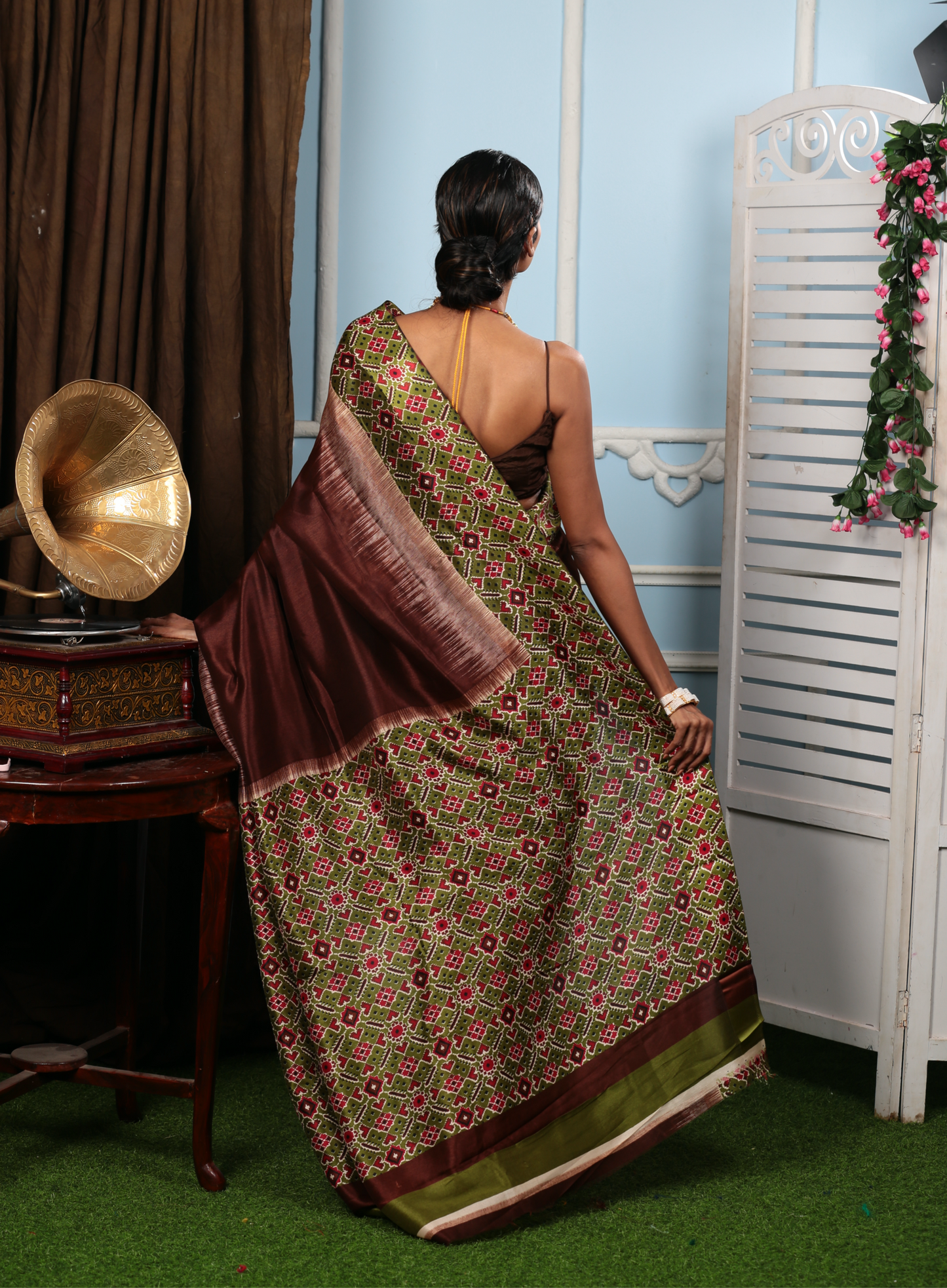 Elegant brown and olive green blend silk saree with intricate Ikat patterns, perfect for festive occasions | Urbane Essence