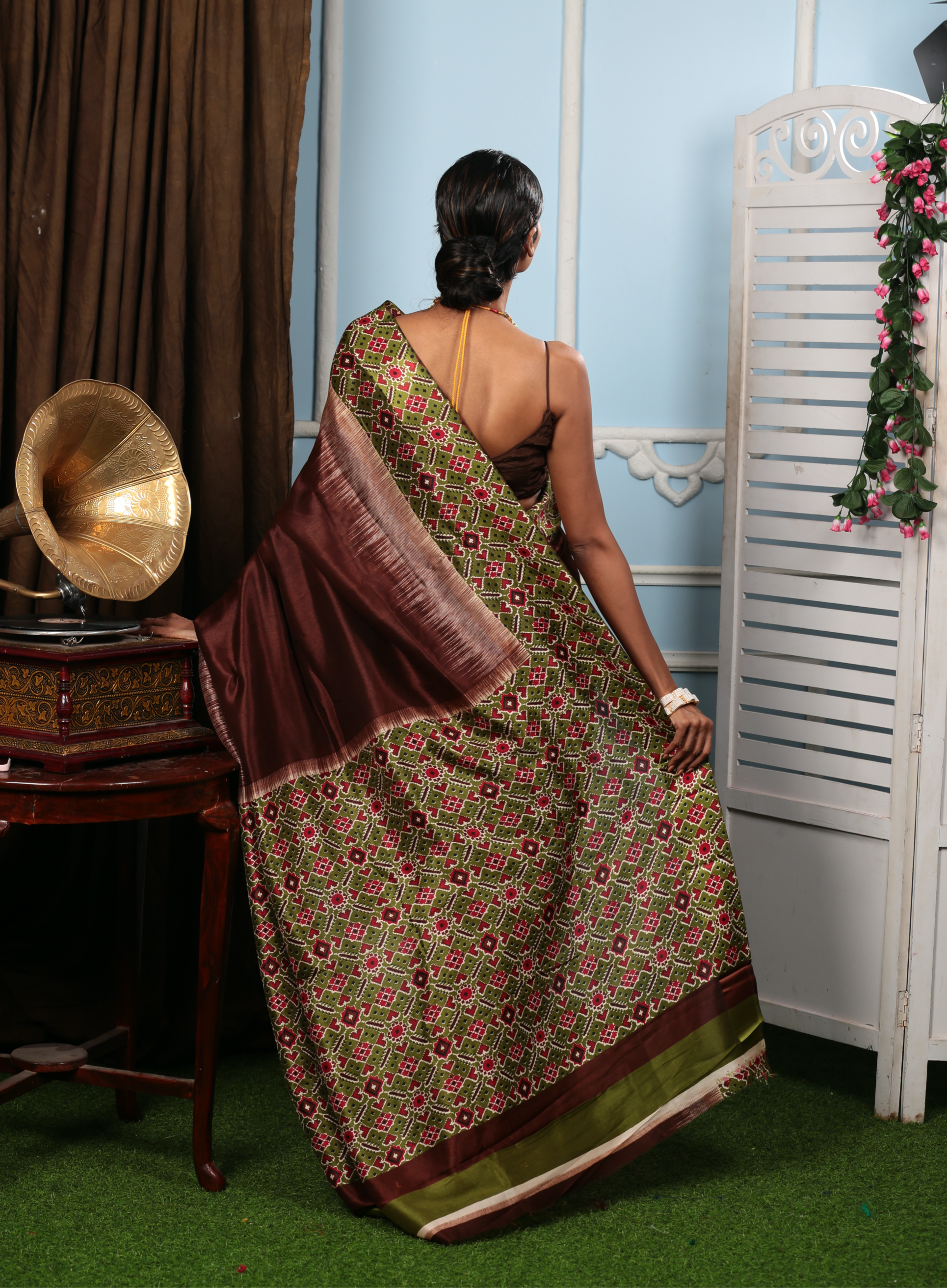 Elegant brown and olive green blend silk saree with intricate Ikat patterns, perfect for festive occasions | Urbane Essence