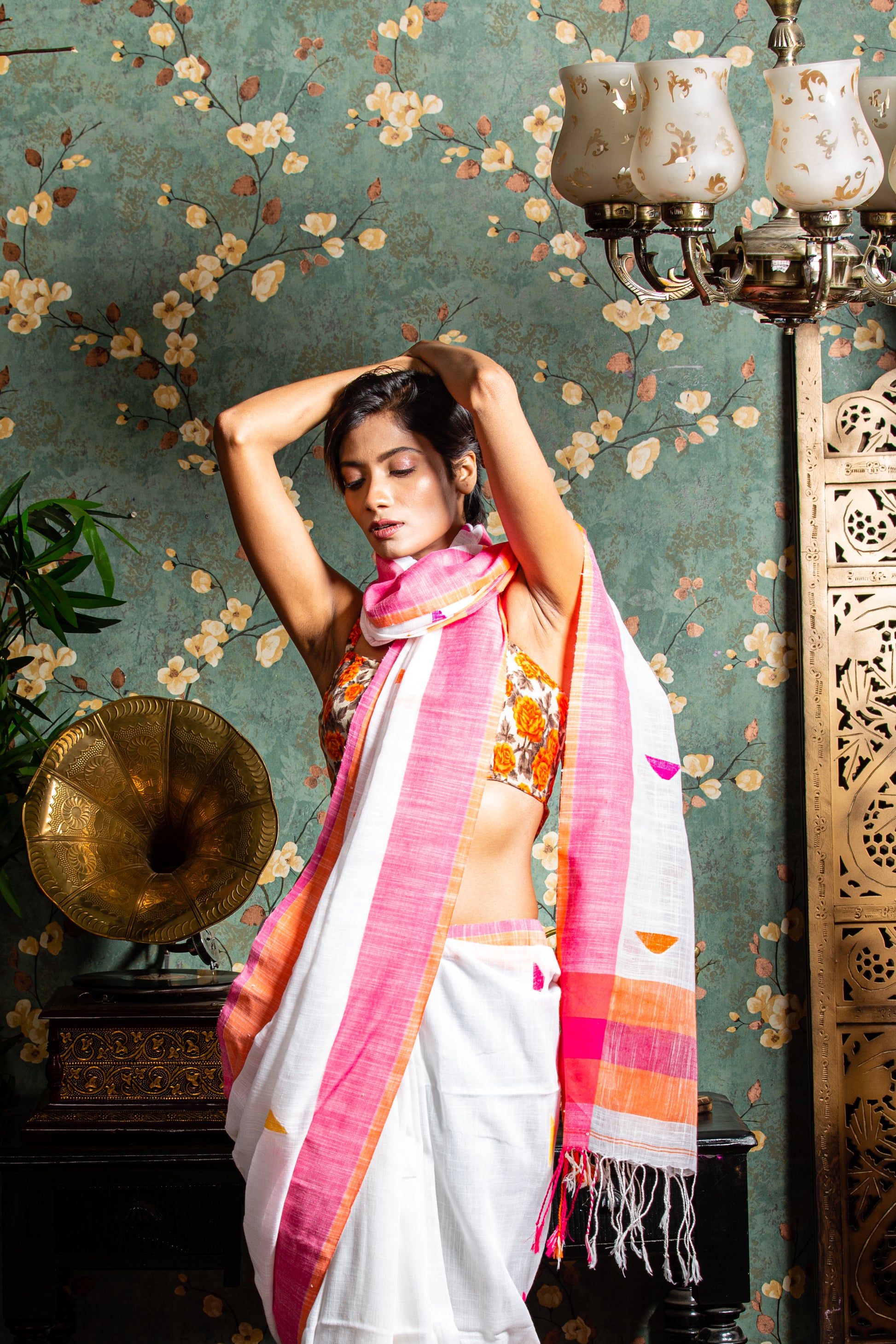 Assam Khadi Saree in soft pink and white with yellow-orange border, handcrafted for traditional occasions | Urbane Essence