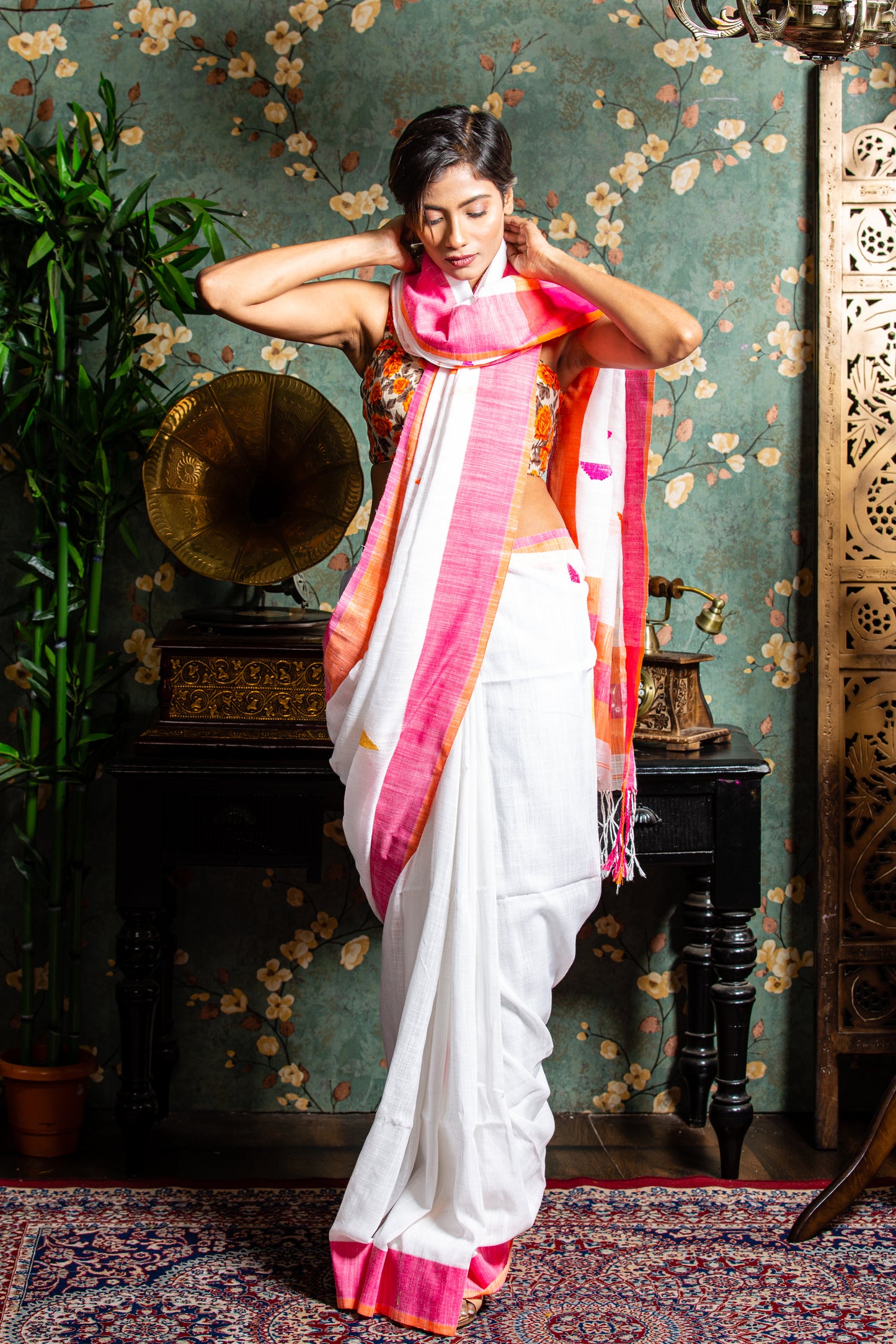 Handcrafted white and pink Assam Khadi Saree with yellow/orange border, perfect for festive occasions | Urbane Essence