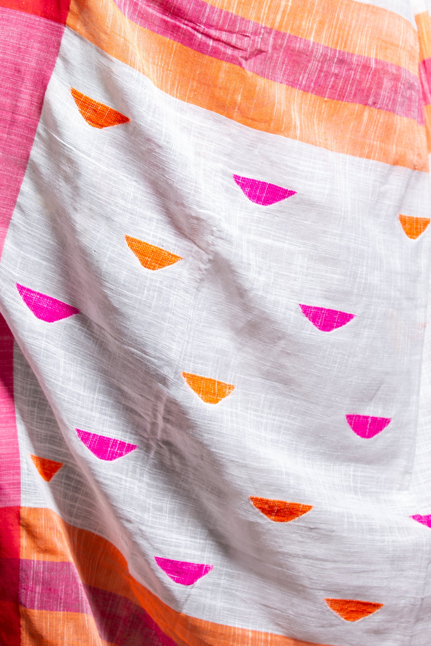 Handcrafted Assam Khadi Saree in white with pink, orange, and yellow borders, suitable for festive occasions | Urbane Essence