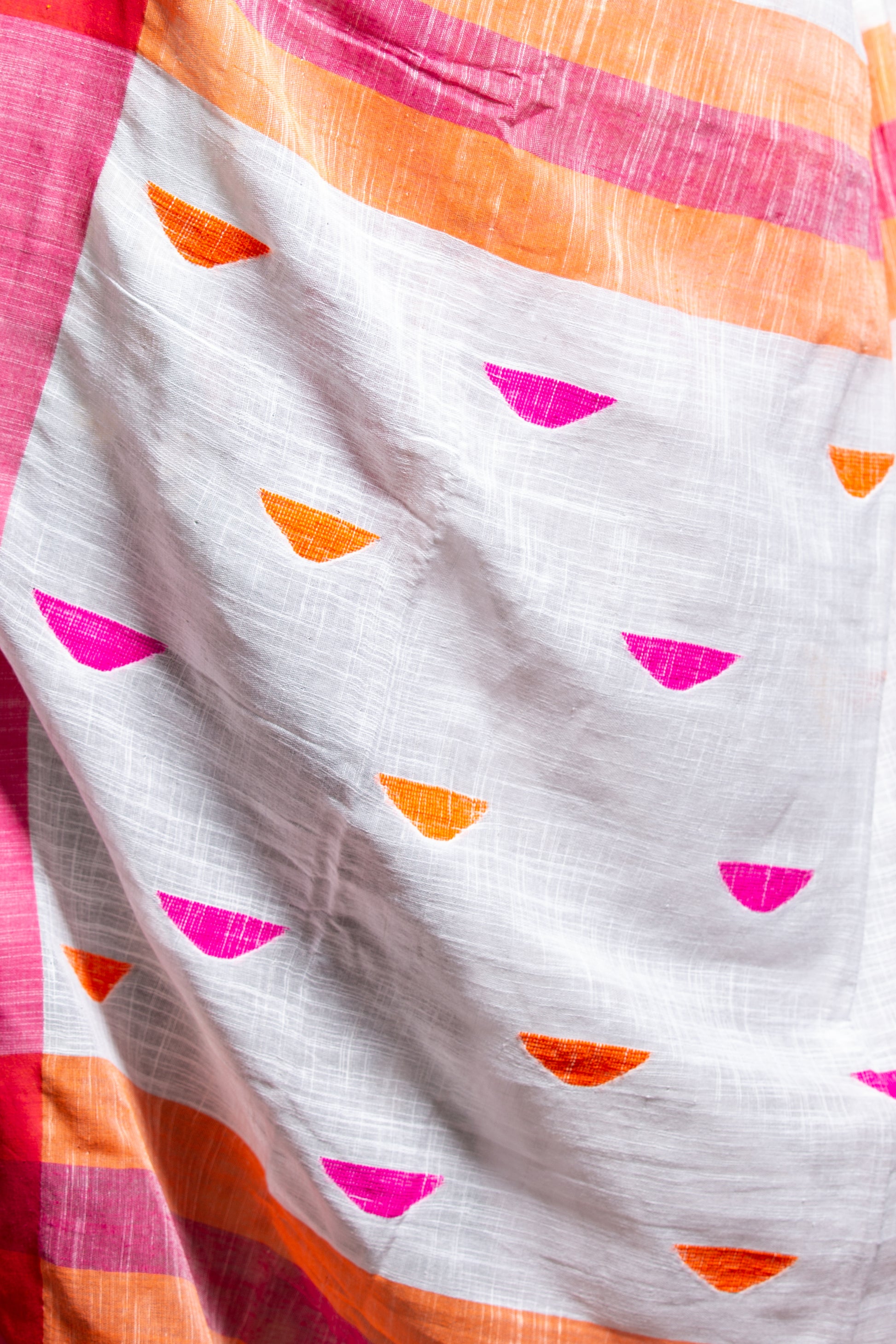 Handcrafted Assam Khadi Saree in white with pink, orange, and yellow borders, suitable for festive occasions | Urbane Essence