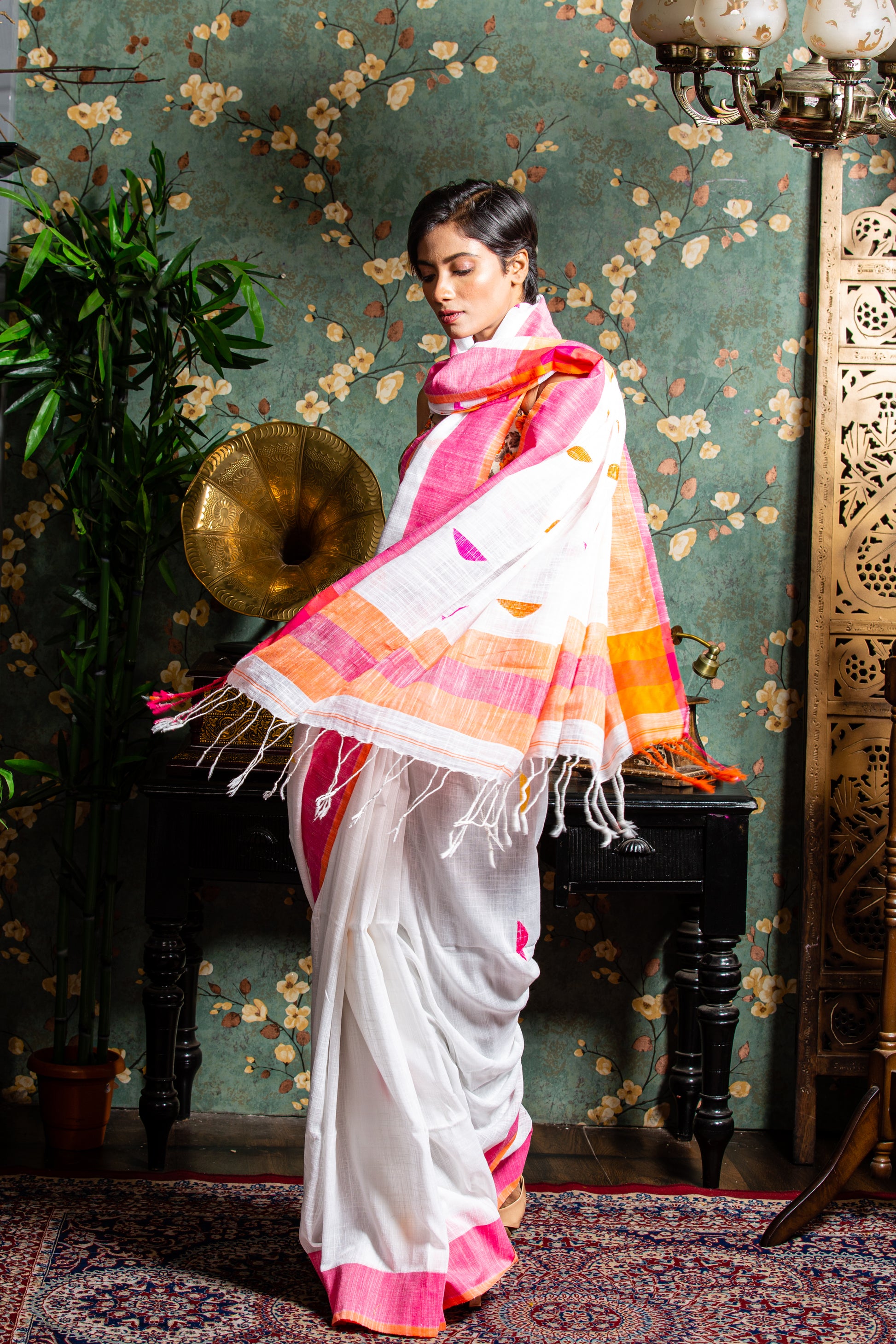 Handcrafted Assam Khadi Saree in soft pink and white with yellow-orange borders, ideal for festive occasions | Urbane Essence