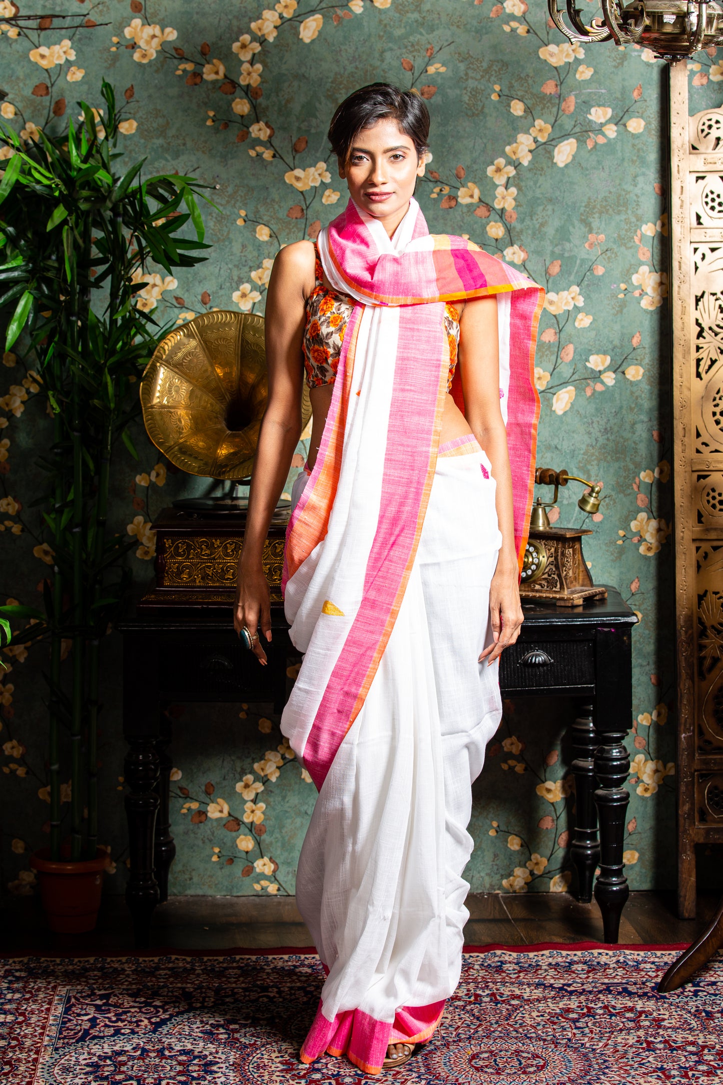 Assam Khadi Saree in soft pink and white with yellow-orange borders, handcrafted for traditional elegance | Urbane Essence