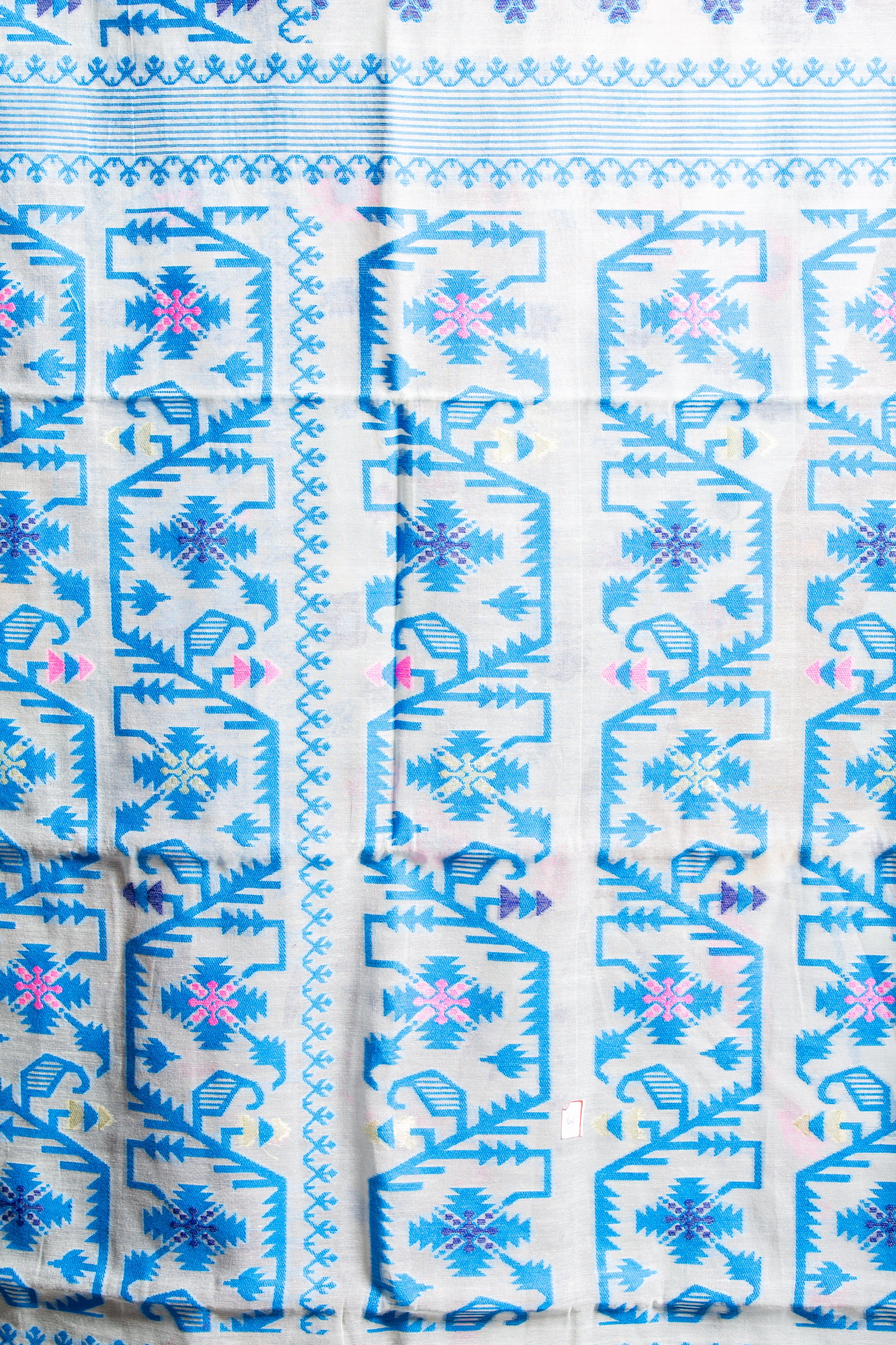 White cotton Jamdani saree with blue and pink geometric patterns, suitable for Pujas and work | Urbane Essence