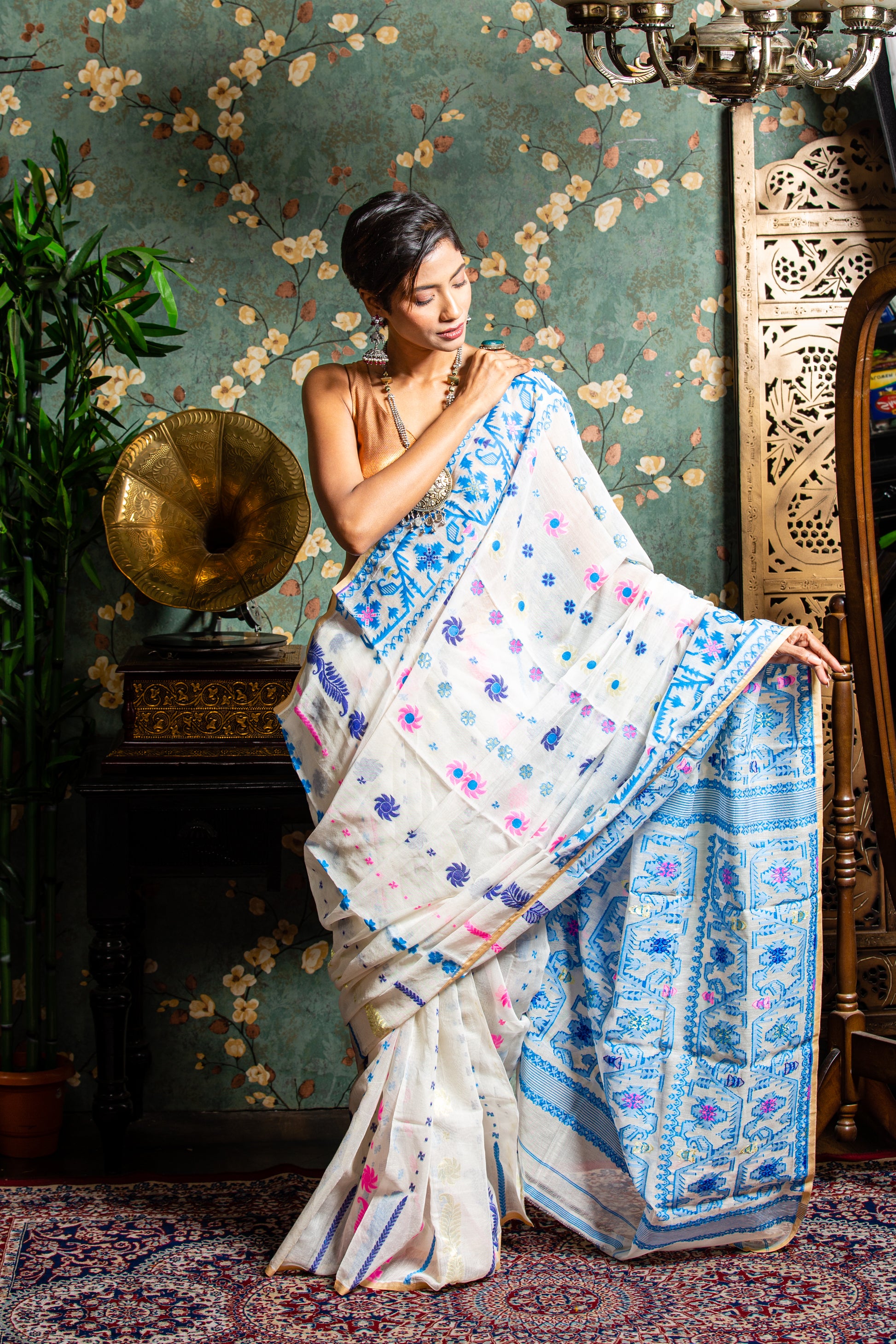 White Jamdani cotton saree with blue and pink floral motifs, perfect for Pujas or work | Urbane Essence