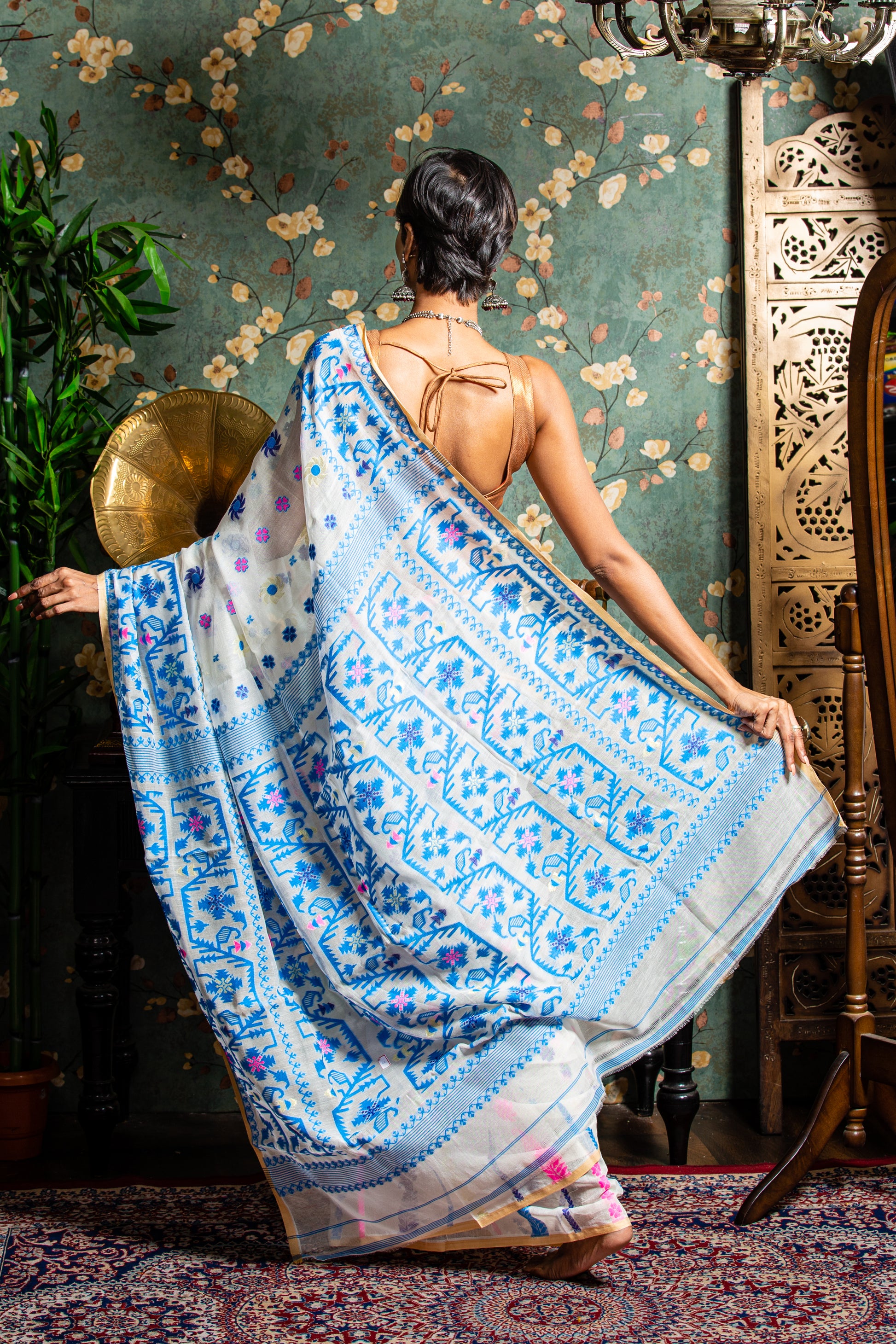 White cotton Jamdani saree with blue and pink floral motifs, perfect for Pujas or work | Urbane Essence