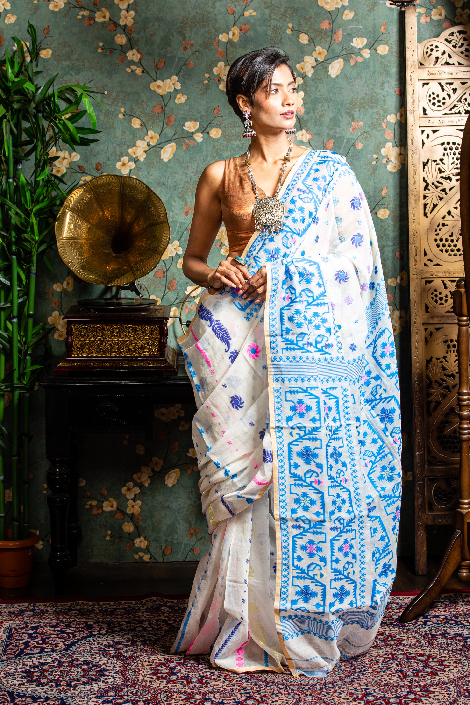 White Jamdani cotton saree with blue and pink floral motifs, perfect for Pujas or work | Urbane Essence