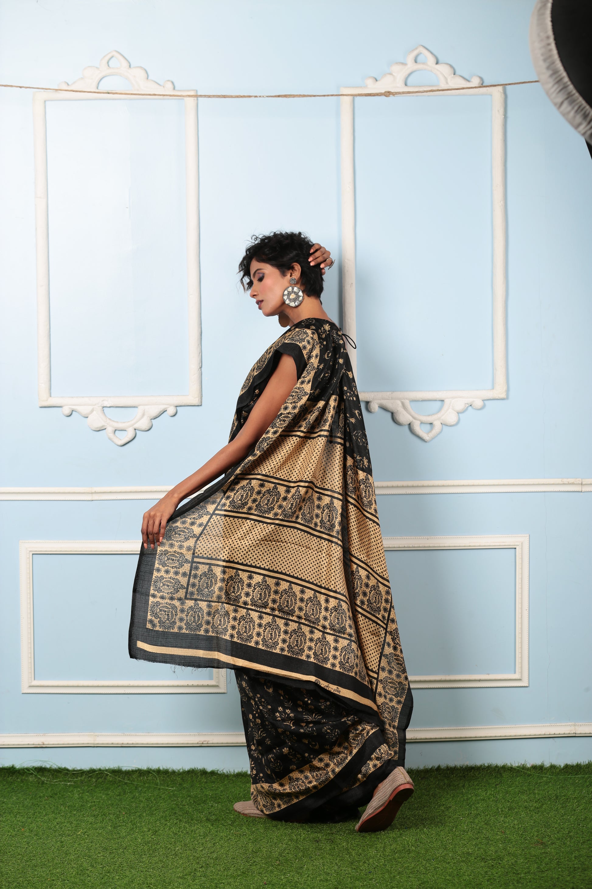 Woman in black and beige Temple Fabric Blend Saree with prominent patterns, suitable for work | Urbane Essence