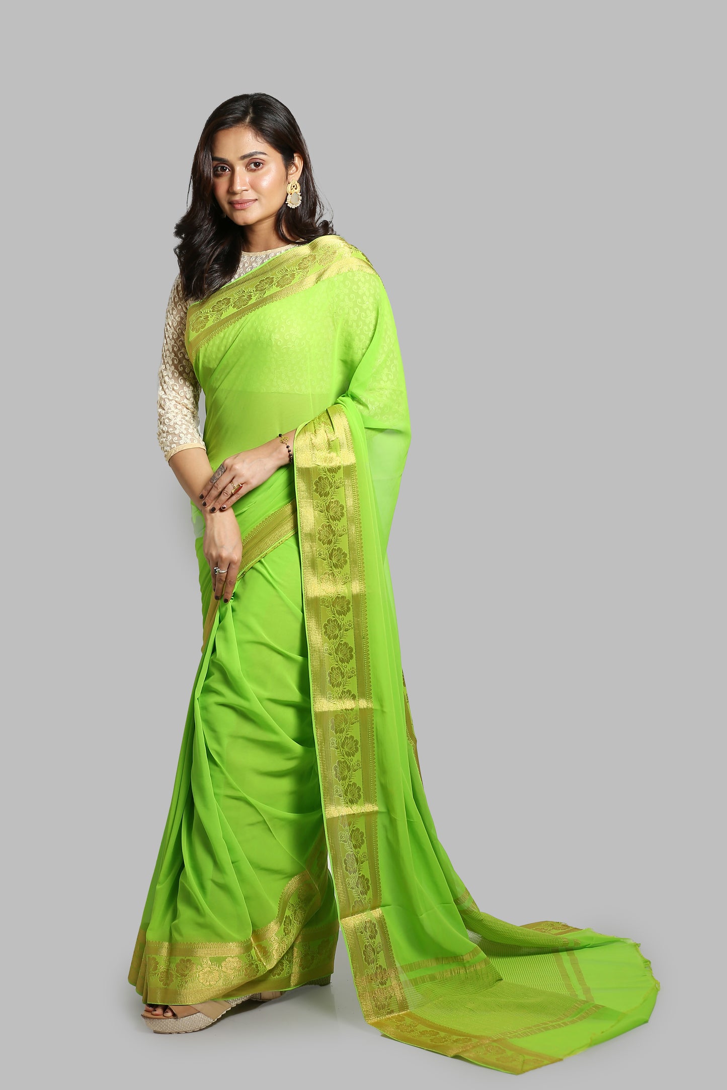 Green chiffon-blend saree with broad golden floral zari border and busy pallu design, perfect for daily wear | Urbane Essence