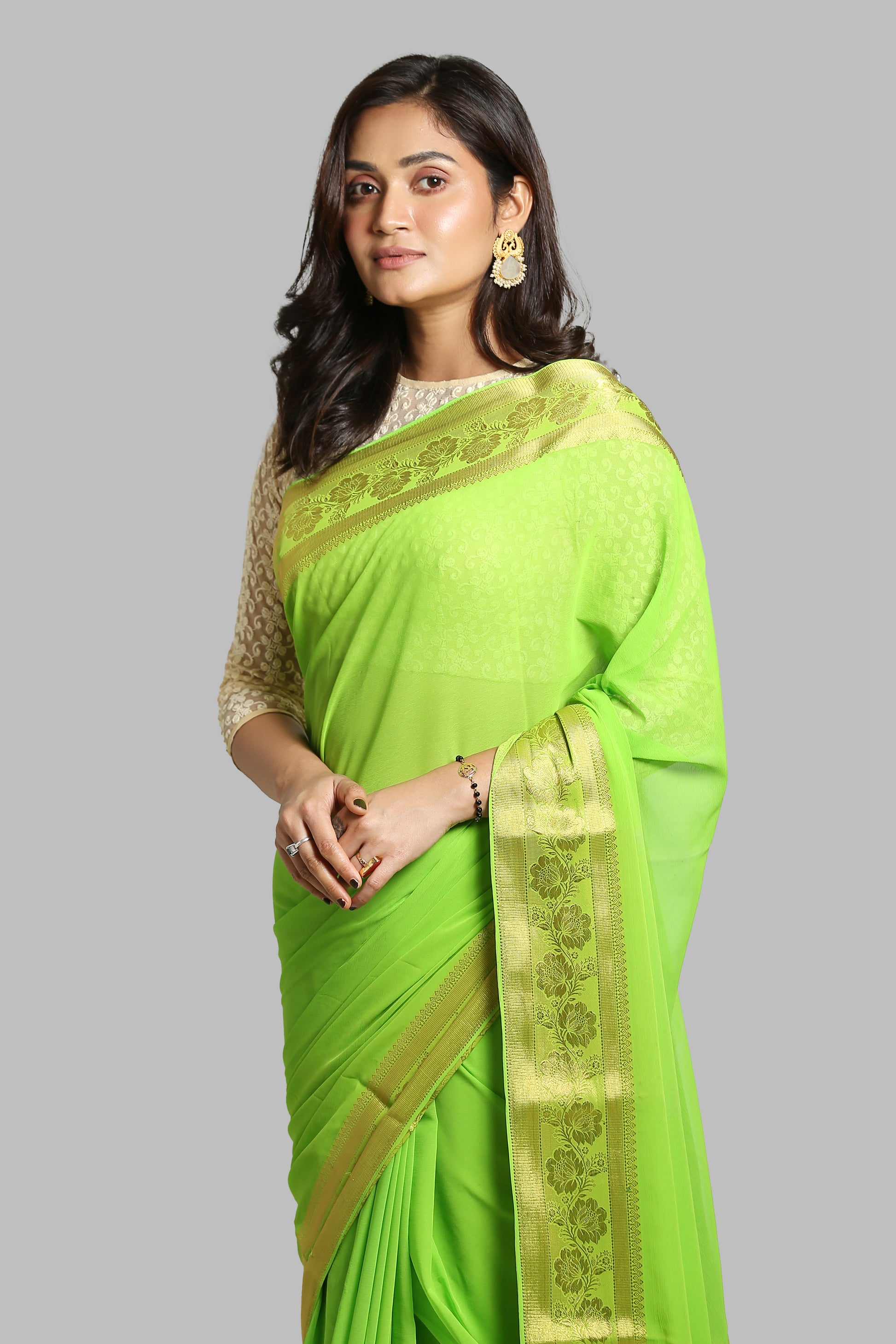 Green chiffon-blend saree with broad golden floral zari border, suitable for daily wear. | Urbane Essence