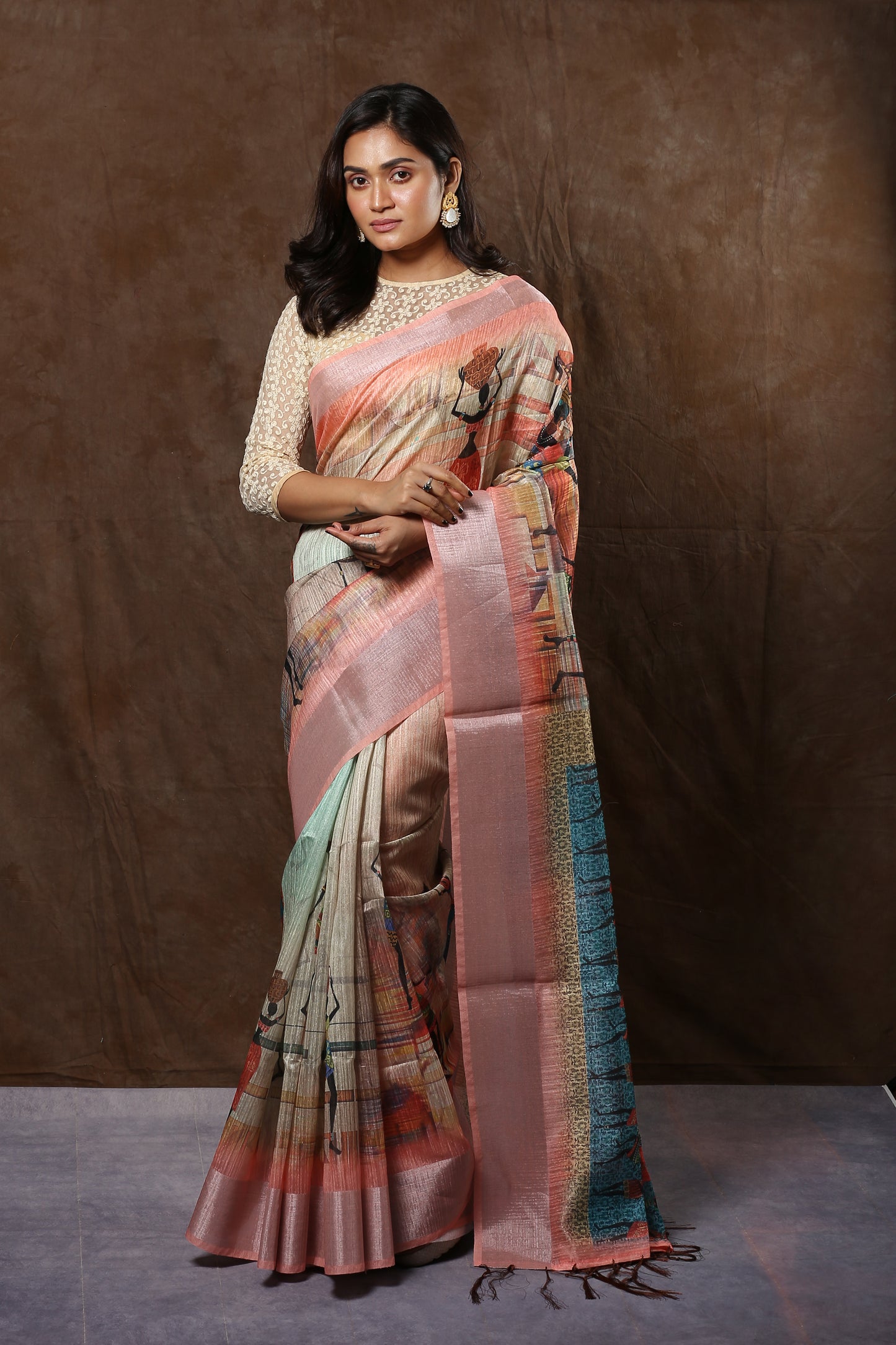 Cream raw silk saree with ancient wall painting figures, broad silver border, and Kolka pallu, perfect for weddings | Urbane Essence